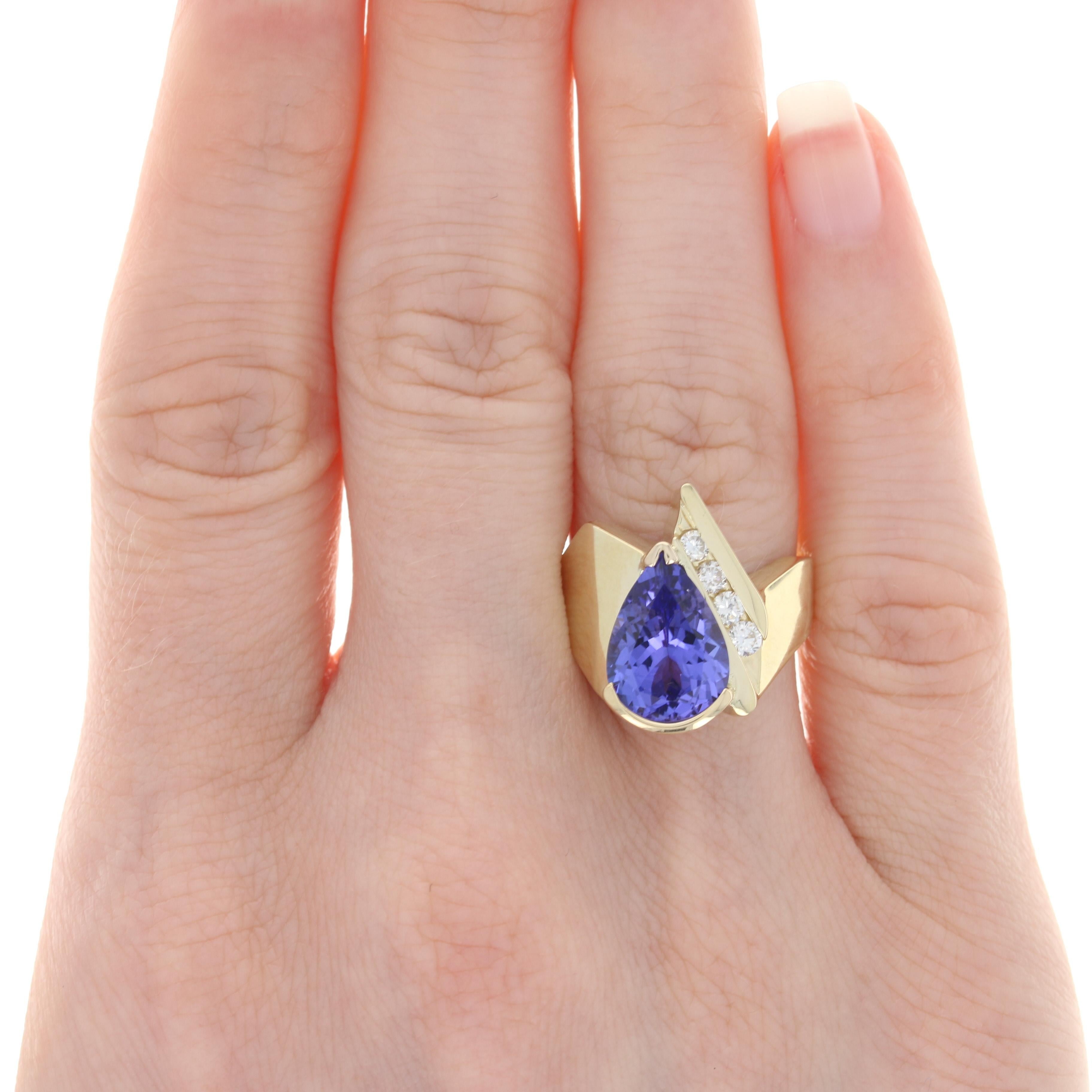 Size: 6 1/4

Metal Content: 14k Yellow Gold

Stone Information: 
Genuine Tanzanite
Treatment: Routinely Enhanced
Carat(s): 4.10ct
Cut: Pear
Color: Purple

Natural Diamonds
Carat(s): .24ctw
Cut: Round Brilliant
Color: F - G
Clarity: VS1 - VS2

Total