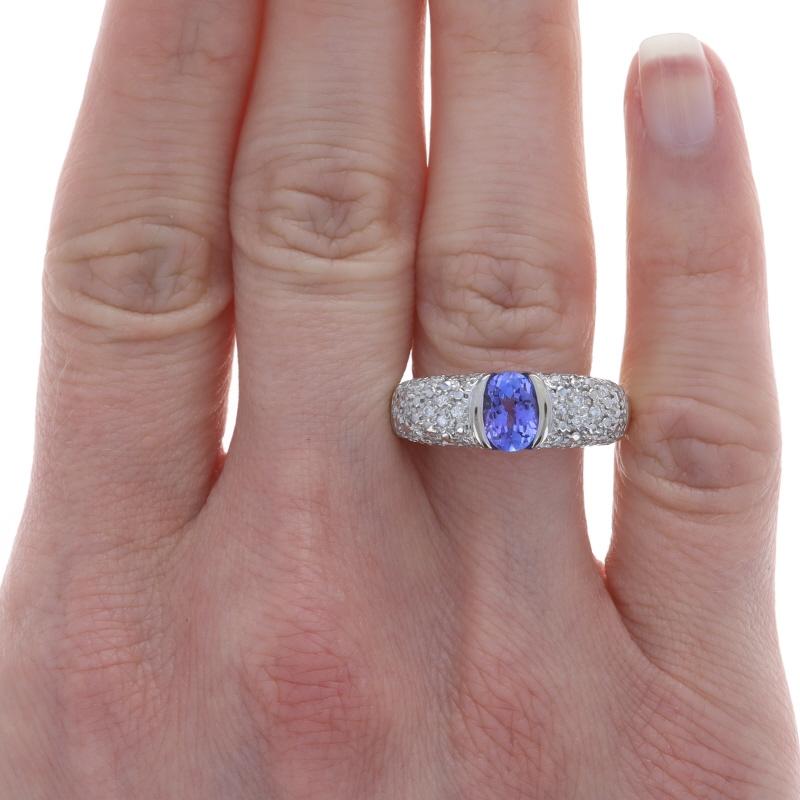 Size: 9 1/4

Metal Content: 18k Yellow Gold & 18k White Gold

Stone Information

Natural Tanzanite
Treatment: Routinely Enhanced
Carat(s): 1.00ct
Cut: Oval
Color: Purple

Natural Diamonds
Carat(s): .33ctw
Cut: Round Brilliant
Color: G - H
Clarity: