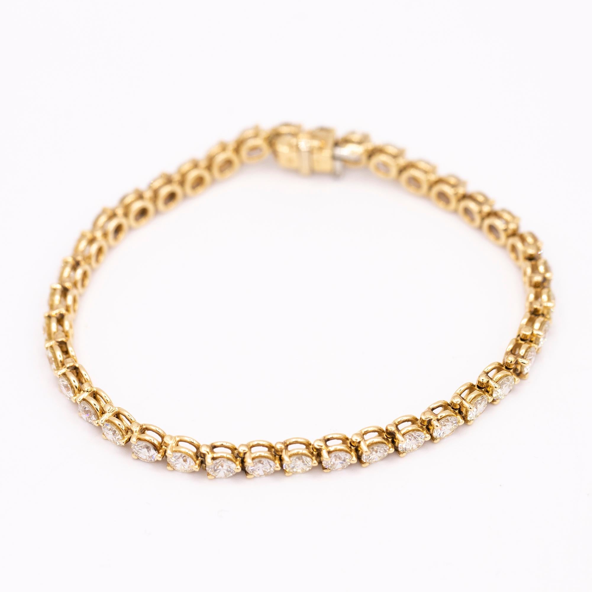 Vintage 14kt yellow gold diamond tennis bracelet. The bracelet has 38 round brilliant cut diamonds that have a total carat weight of 7.60 carats. The diamonds range in color from G-H and have a clarity of SI. The bracelet measures 7 inches in