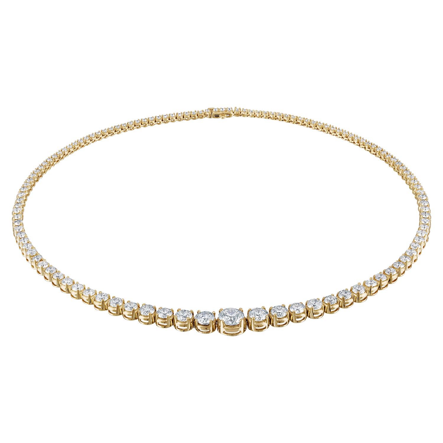 14K Tennis Necklace of graduating Diamonds are the Classic Necklace every woman desires for.
This Necklace is 16 3/4 inches long and has 115 Round Brilliant Diamonds on it totaling to 18.08 Carats of Diamonds. The Center Diamond weight 2.15 Carat.