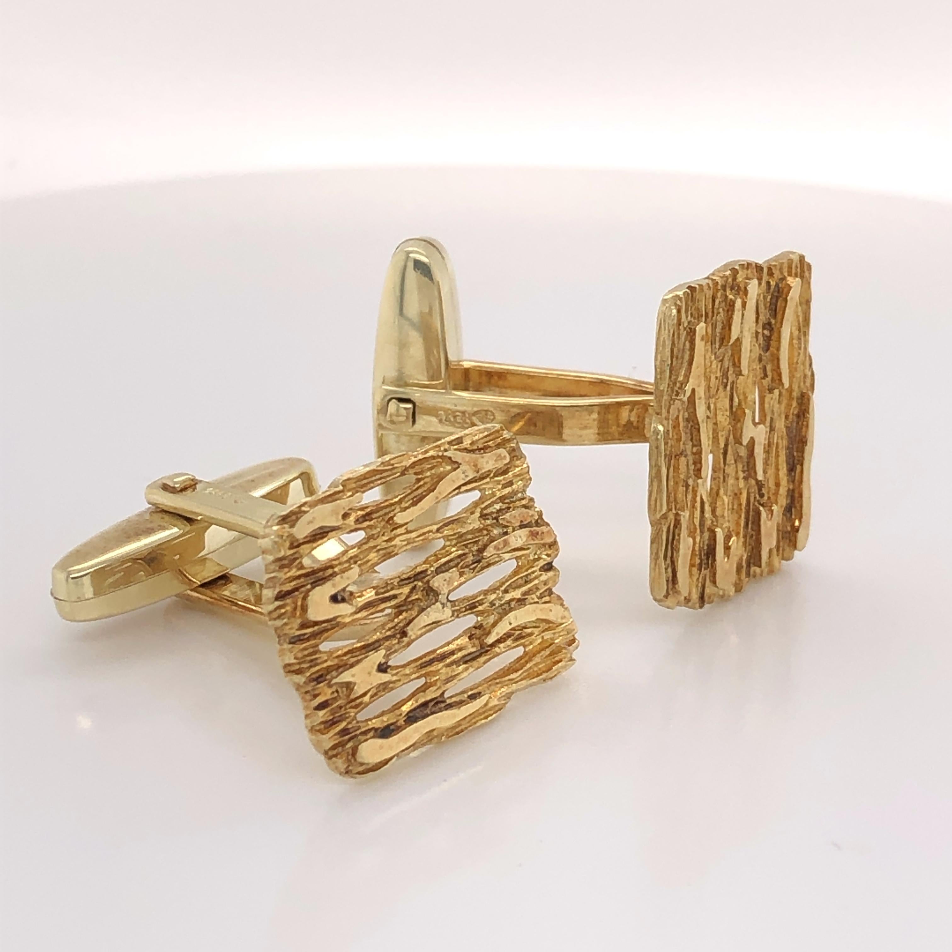 For that tailored look. Abstract design in textured fourteen karat  (14k) yellow gold. Unisex style cuff links with bullet (toggle) backs. Measures 1/2 inch x 3/4 inch. In gift box.