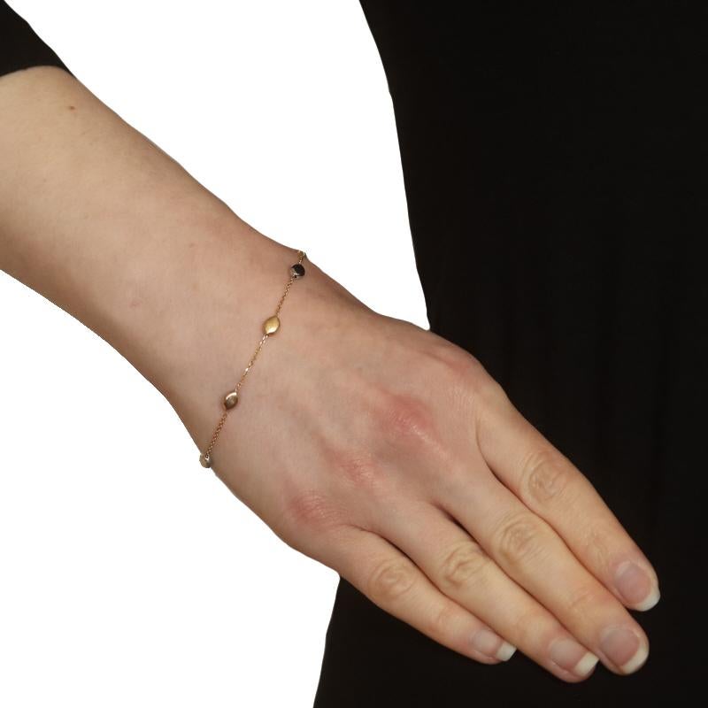 Metal Content: 14k Yellow Gold, 14k White Gold, & 14k Rose Gold

Chain Style: Diamond Cut Cable
Bracelet Style: Chain Station
Fastening Type: Lobster Claw Clasp
Features: Smooth & Textured Finishes
Theme: Dots

Measurements
Length: 7 1/4