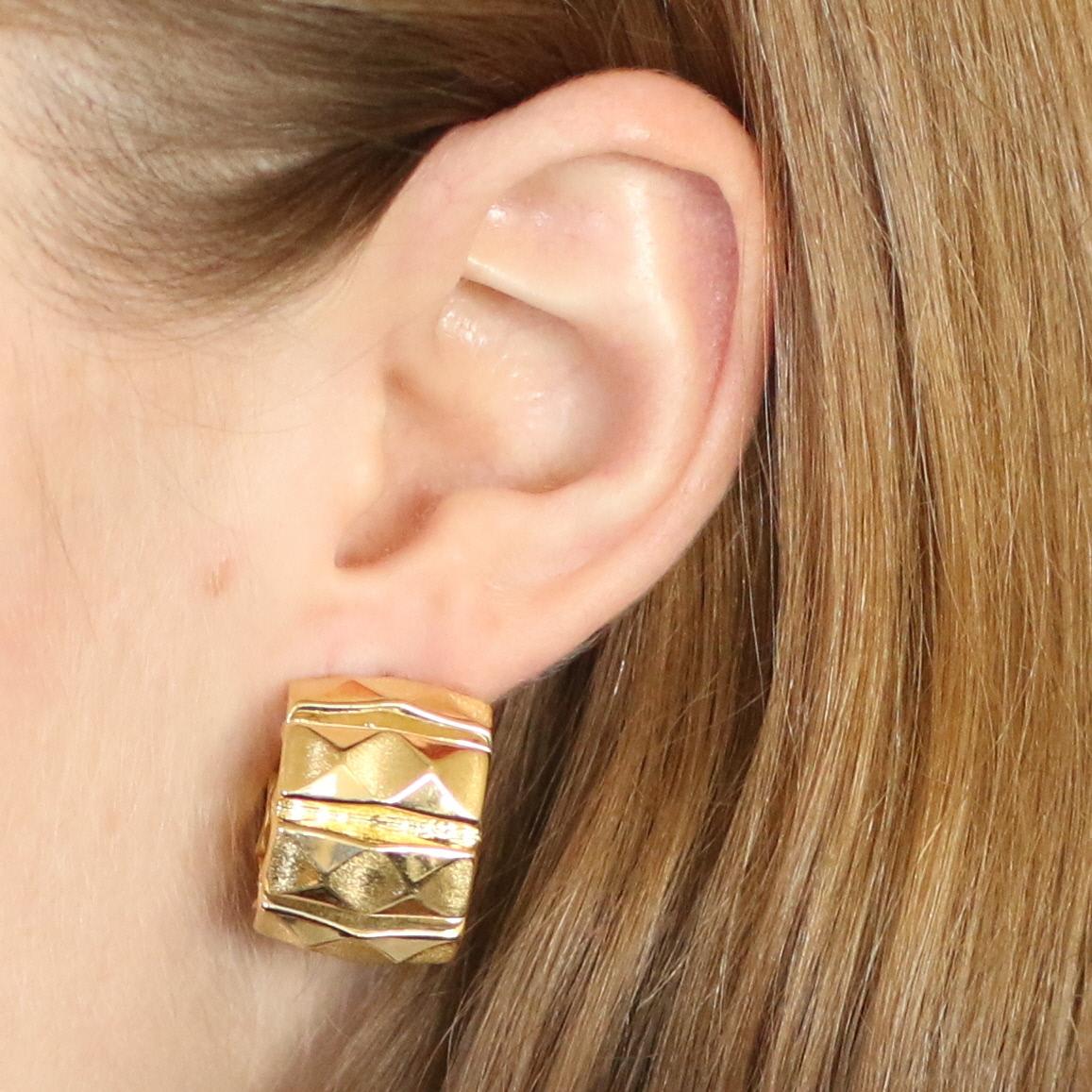 Metal Content: 18k Yellow Gold 

Style: Half-Hoop 
Fastening Type: Omega Closures 
Features: Brushed & Smooth Finishes 

Measurements: 
Tall: 7/8