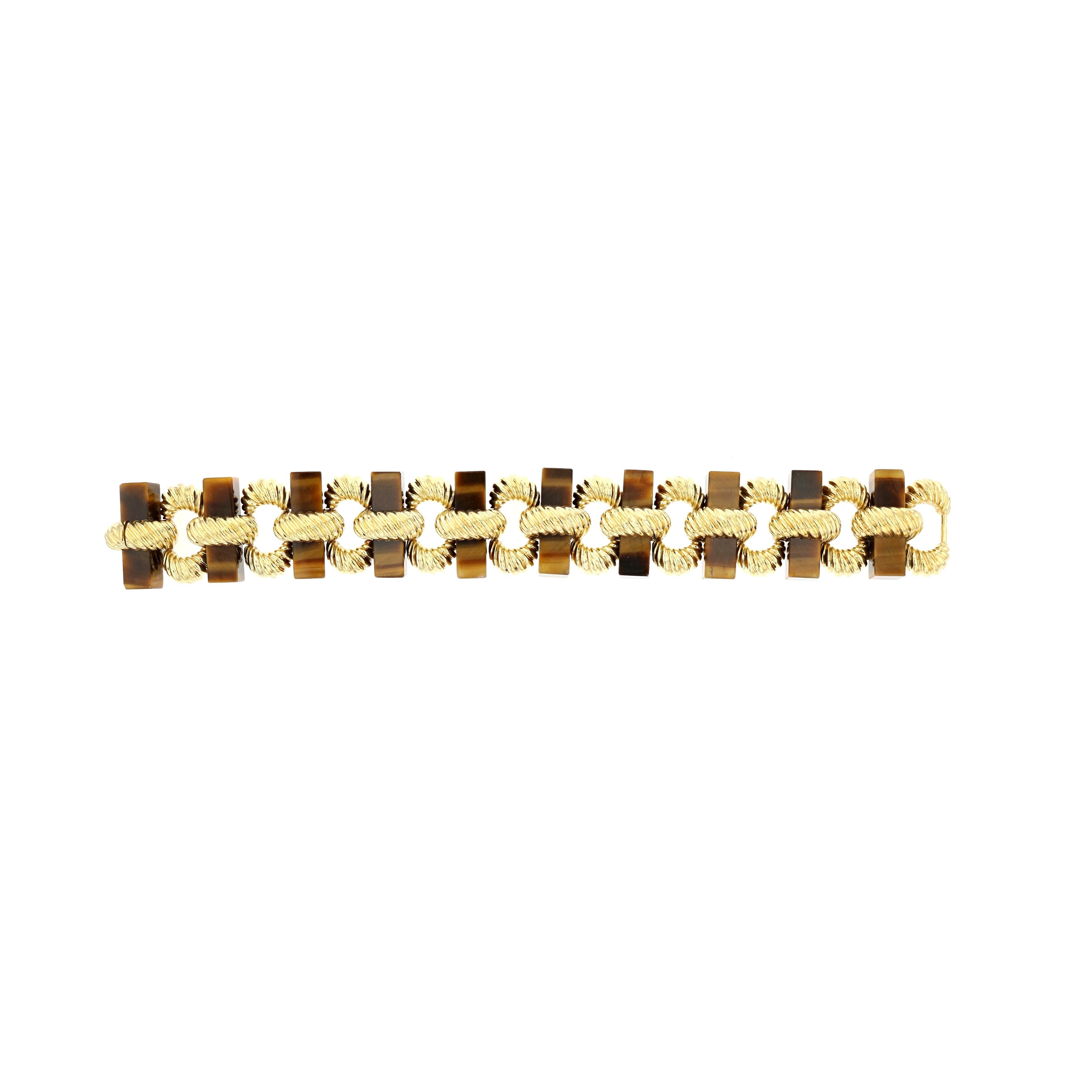 18K yellow gold bracelet with Tiger's Eye bars.  The gold work is ridged with great texture.  Bracelet measures 7 1/2 inches long and 15/16 inches wide.  Circa 1970s.
