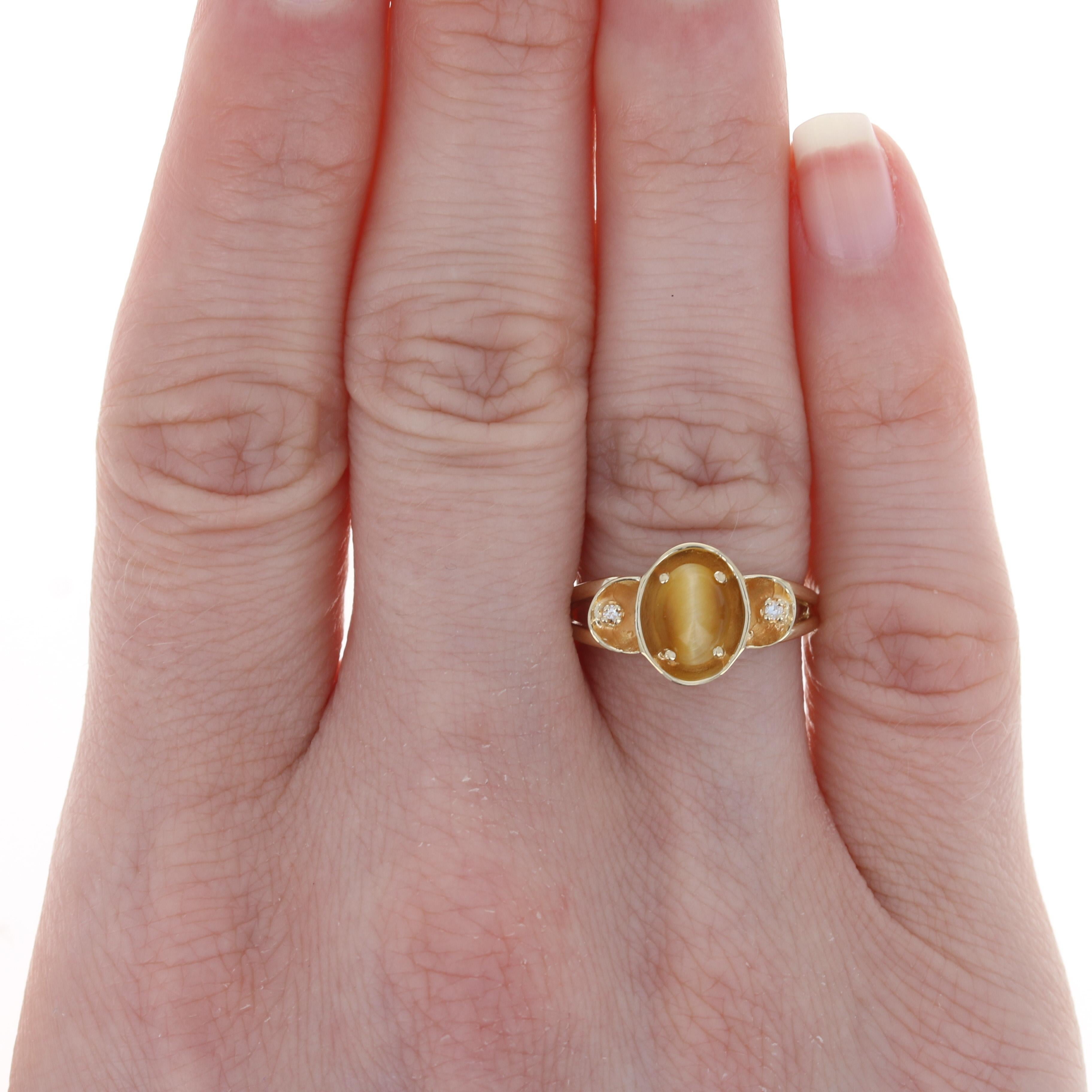 Size: 6 1/2
 Sizing Fee: Up 2 sizes for $25 or Down 2 sizes for $20 
 
 Metal Content: 14k Yellow Gold 
 
 Stone Information: 
 Genuine Tiger's Eye
 Cut: Oval Cabochon
 Size: 7.2mm x 5.3mm 
 
 Natural Diamonds
 Total Carats: .02ctw 
 Cut: Single

