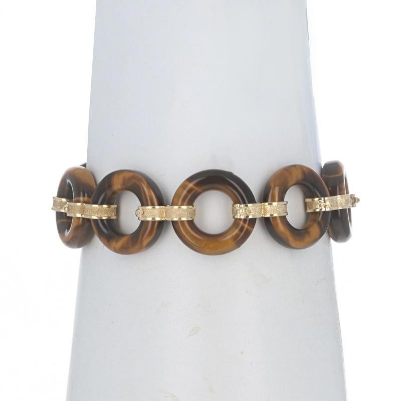 Metal Content: 14k Yellow Gold

Stone Information

Natural Tiger's Eye

Style: Link
Fastening Type: Fold-Over Clasp with Safety Clasp
Theme: Circles
Features: Smooth & Textured Finishes

Measurements

Length: 7