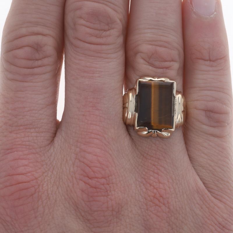 Size: 10 1/2
Sizing Fee: Up 1 size for $40

Era: Vintage

Metal Content: 10k Yellow Gold

Stone Information

Natural Tiger's Eye
Color: Brown

Style: Solitaire

Measurements

Face Height (north to south): 27/32