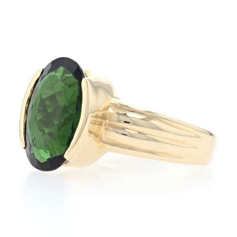 Size: 5 1/2 - 5 3/4

Metal Content: 14k Yellow Gold

Stone Information: 
Genuine Tourmaline
Color: Green
Cut: Oval
Carat: 5.20ct

Style: Cocktail Solitaire
Face Height (north to south): 9/16