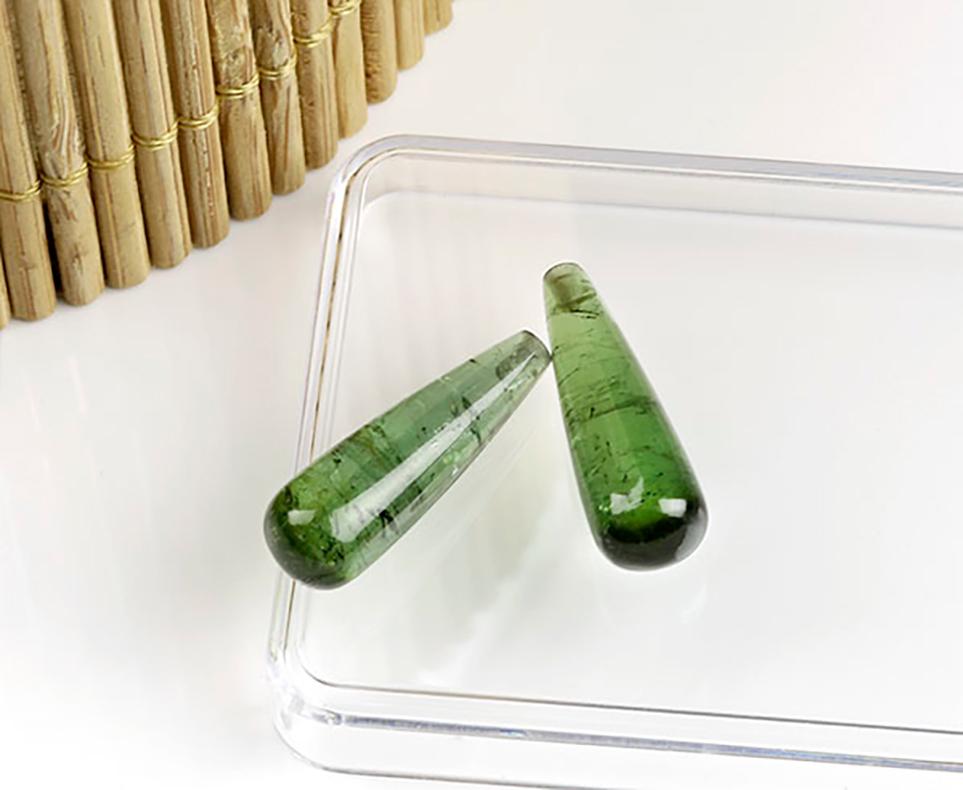 Questi orecchini trasformatori contemporanei sono realizzati in oro giallo 18 carati con tormaline verdi naturali staccabili (18 mm o più, taglio a goccia) e topazi (taglio ottagonale). 

Gli orecchini presentano due diversi elementi dorati: un