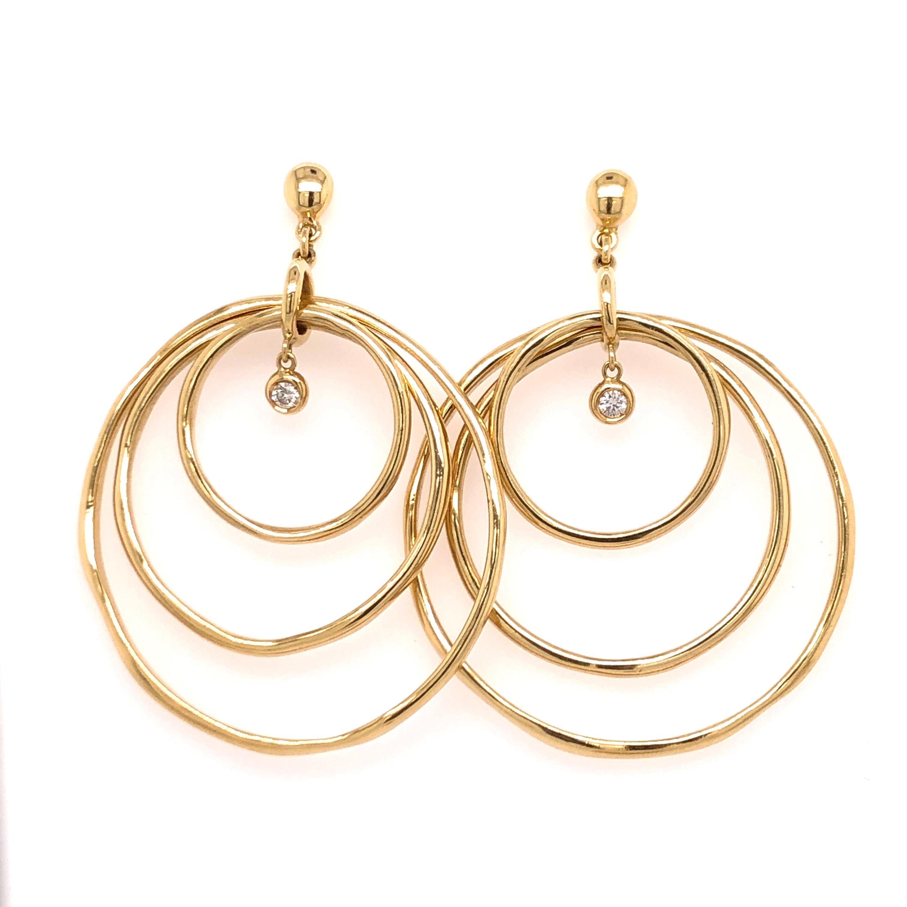 If you are looking for a staple piece with some character these earrings are for you! Straight from Vaid Roma, three 18K yellow gold irregular shaped hoops dangle with a bezel set diamond to accent them.
They are perfect, casual or dressy.
