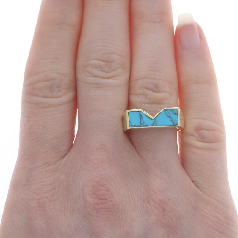 Size: 8 1/2

Metal Content: 14k Yellow Gold

Stone Information
Natural Turquoise
Treatment: Routinely Enhanced
Cut: Inlay
Color: Greenish Blue

Style: Band
Theme: Geometric

Measurements
Face Height (north to south): 9/32