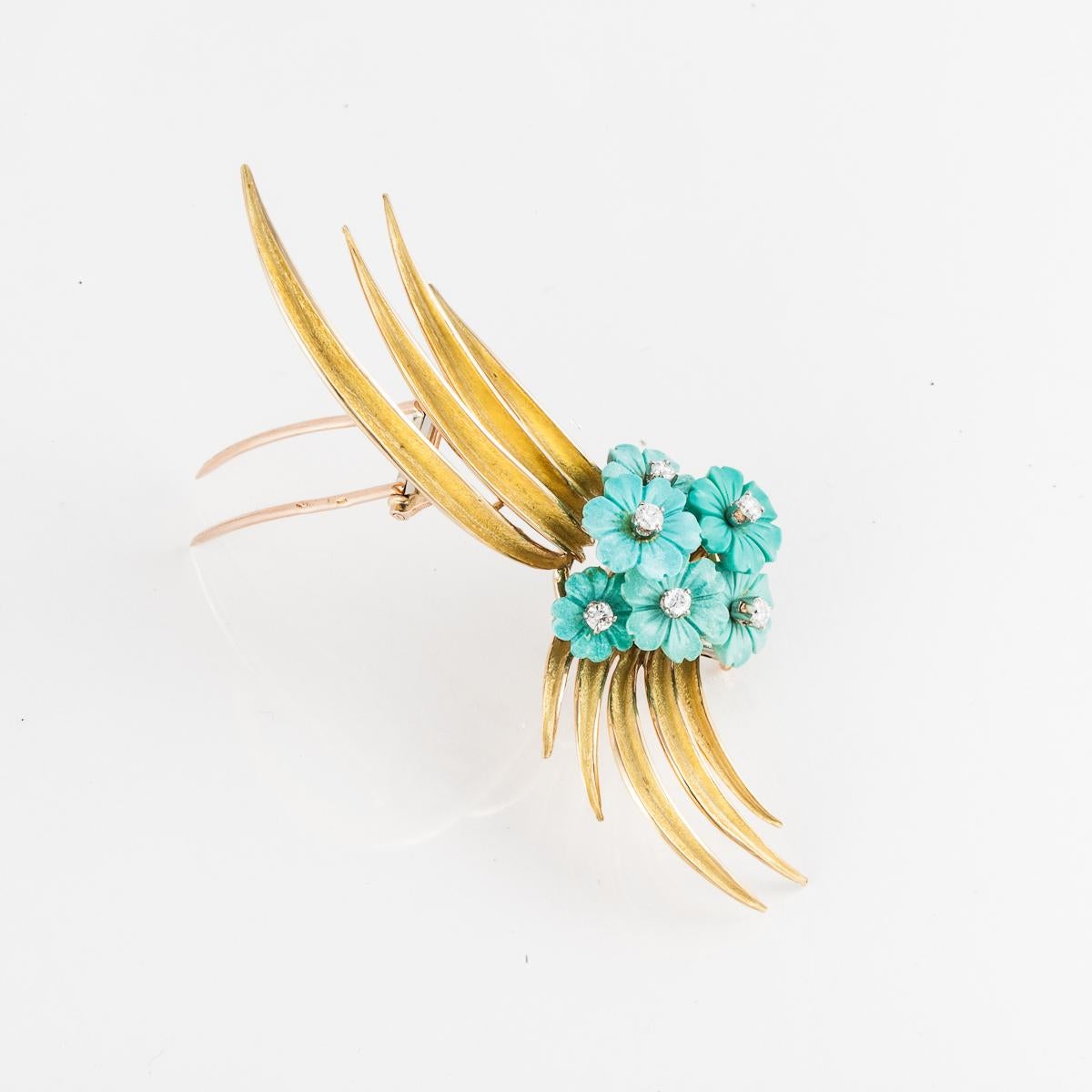 Spray style brooch composed of 18K yellow gold with six carved turquoise flowers and round diamonds.  The six round diamonds total 0.50 carats.  French hallmarks.  Pin measures 3 1/8 inches by 2 inches.