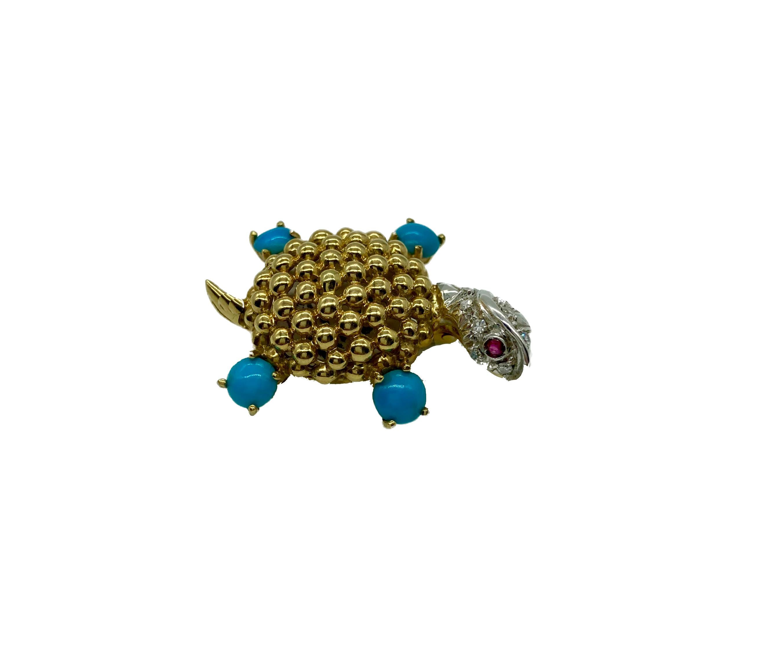 A petite textured gold turtle brooch with turquoise legs, a diamond head, and ruby eyes. Circa 1970s.