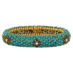 Bracelet en or jaune avec treillis de turquoises, saphirs et diamants