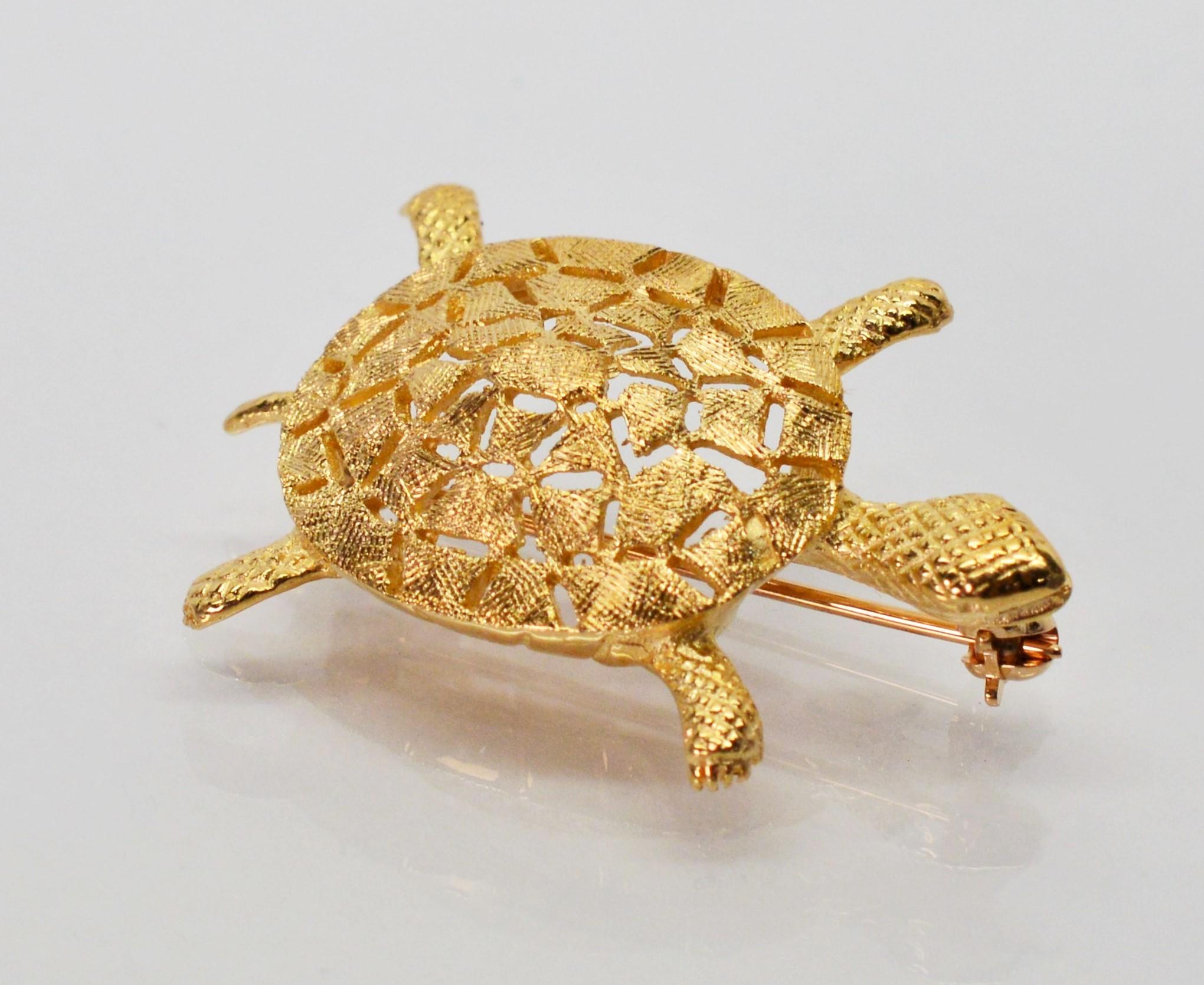 Accompany your outfit with this adorable fourteen carat yellow gold turtle pin brooch. A positive omen of good fortune, the turtle signifies longevity and great patience. Textured gold finishes distinguish the head, feet and shell of this little