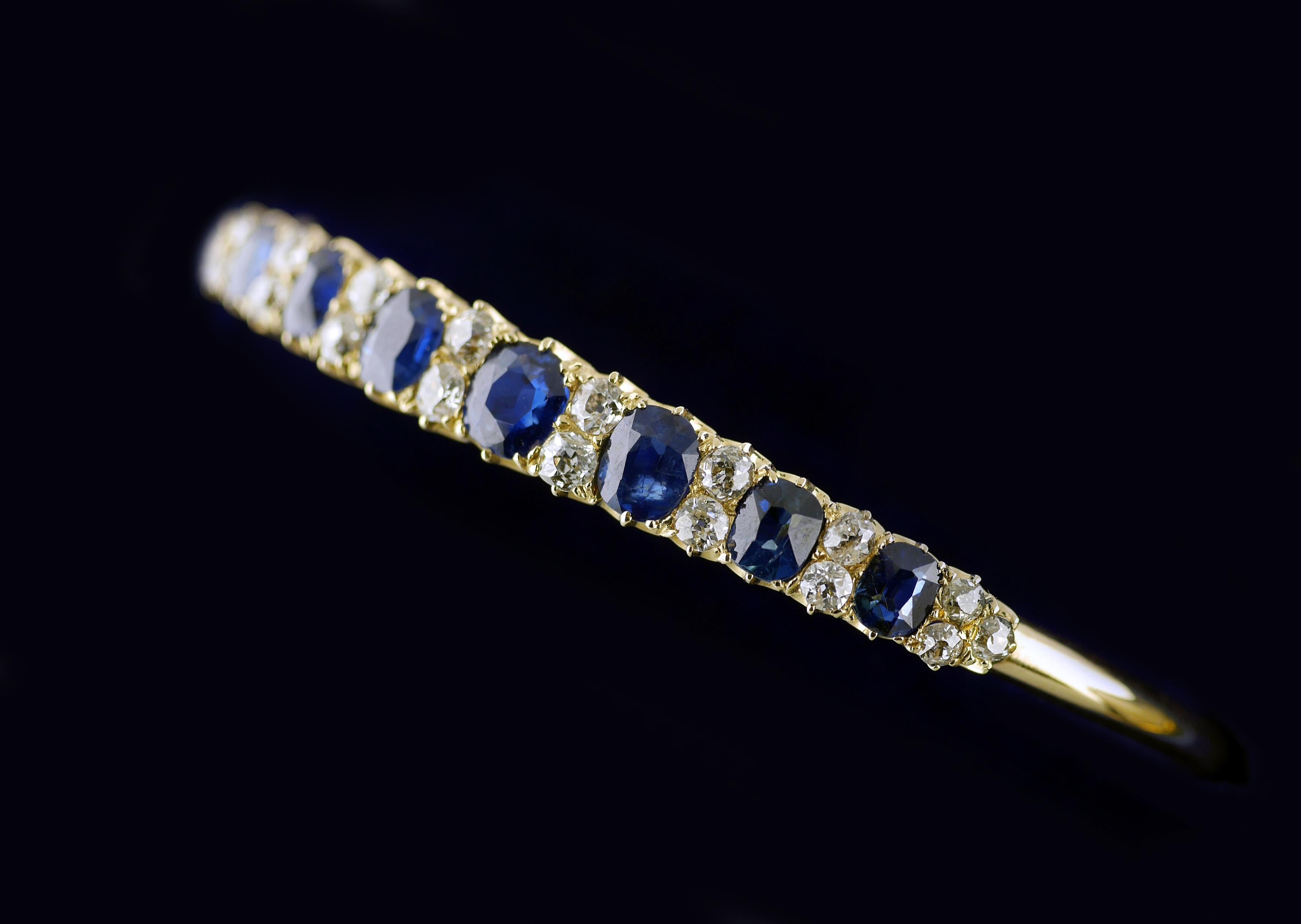 Seven natural, untreated blue sapphires in a period, Victorian bangle (bracelet) mounted with white diamonds dating from Circa 1860.

18ct yellow gold bangle set with 7 extremely well matched, natural untreated Sapphires with a total weight of 4.5ct