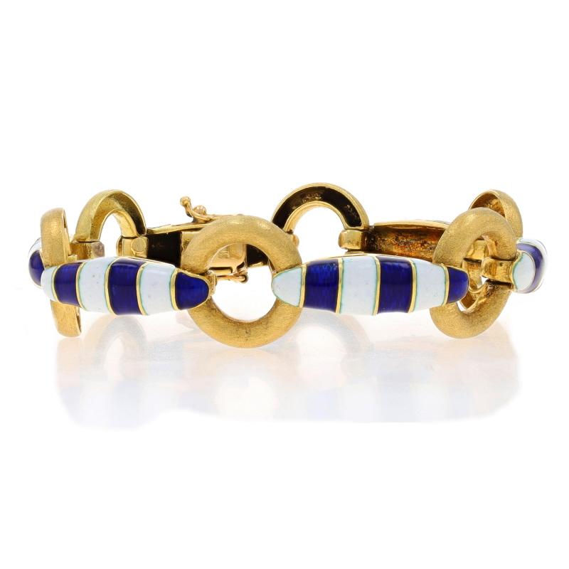 Era: Vintage

Metal Content: 18k Yellow Gold

Material Information
Enamel
Color: Blue & White

Style: Link
Fastening Type: Tab Box Clasp with Two Side Safety Clasps
Theme: Circle Stripe, Nautical
Features: Brushed Detailing

Measurements
Length: 6