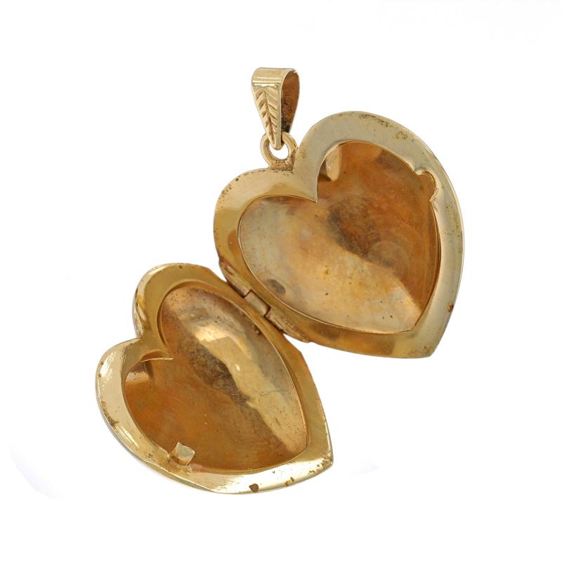 Era: Vintage

Metal Content: 14k Yellow Gold

Style: Locket
Theme: Floral Scroll Heart, Love
Features: Smooth & Textured Finishes; Two Photo Frames

Measurements

Tall (from stationary bail): 1 3/16