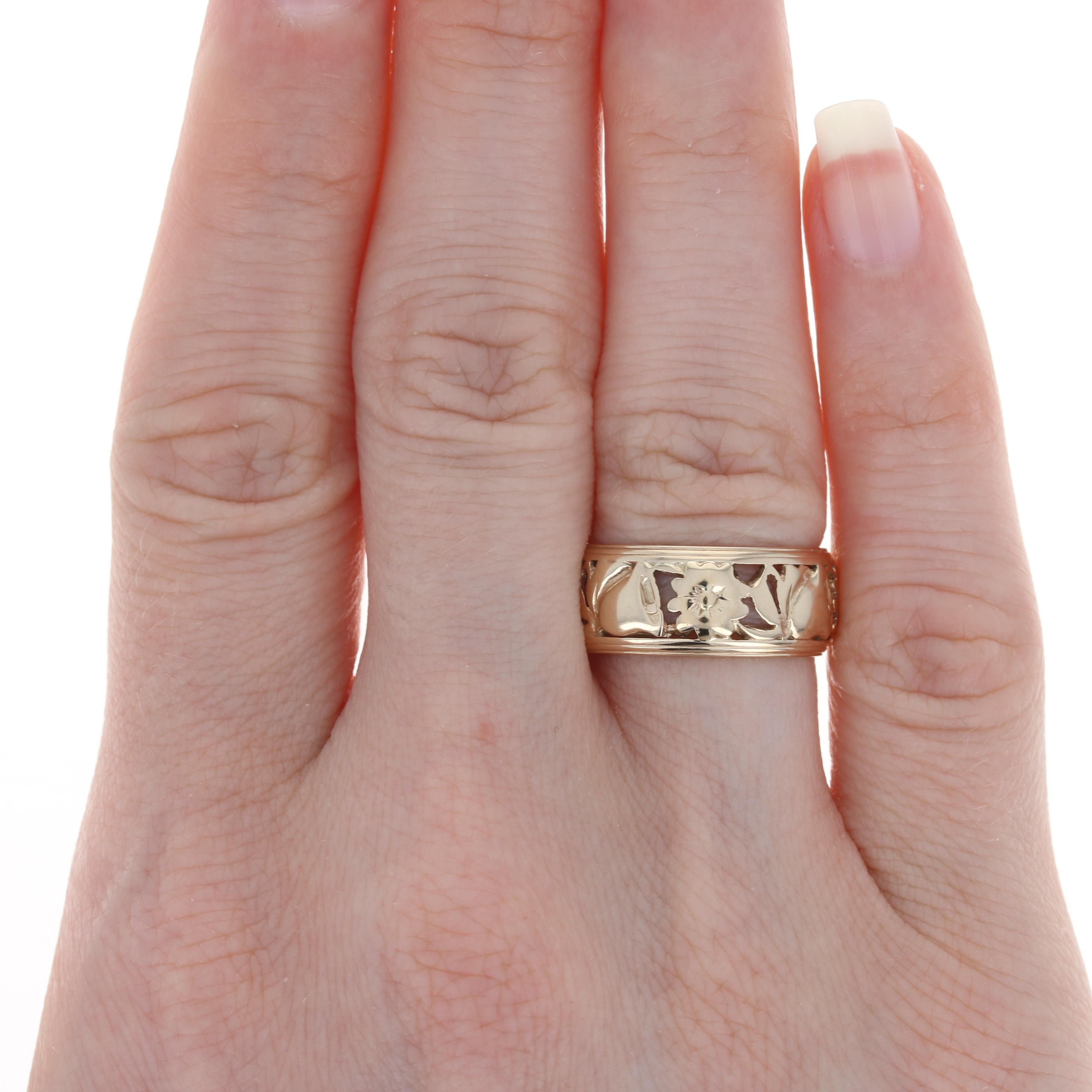 Size: 6 1/4
 
 Era: Vintage
 
 Metal Content: 14k Yellow Gold
 
 Style: Band
 Theme: Flowers & Bells
 Features: Open Cut Design
 
 Face Height (north to south): 11/32