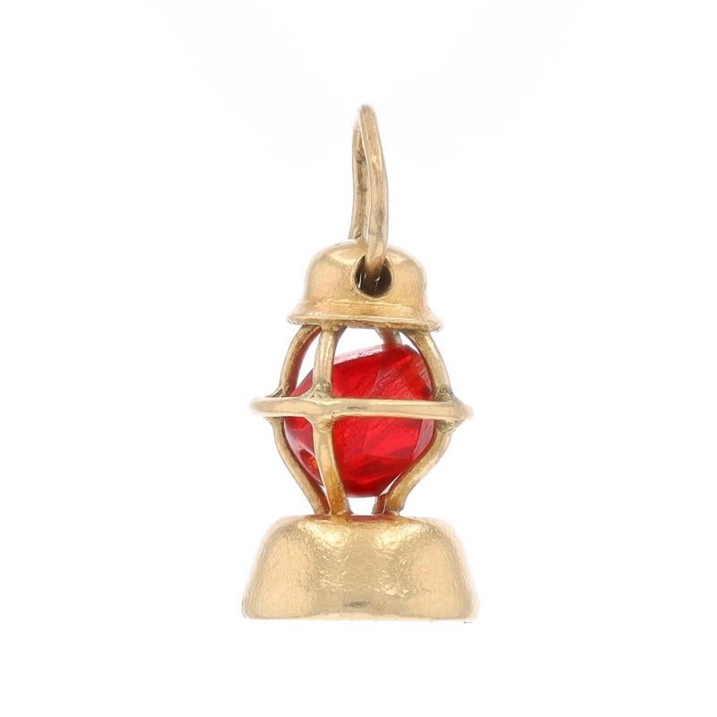 Era: Vintage

Metal Content: 14k Yellow Gold

Stone Information
Glass
Cut: Faceted Bead
Color: Red

Theme: Railroad Lantern, Locomotive Train Transportation

Measurements
Tall: 1/2