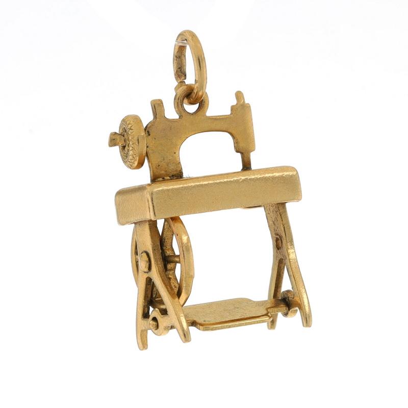 Era: Vintage

Metal Content: 14k Yellow Gold

Theme: Treadle Sewing Machine, Textile Arts
Features: The treadle, balance wheel, and band wheel move.

Measurements

Tall (from stationary bail): 23/32