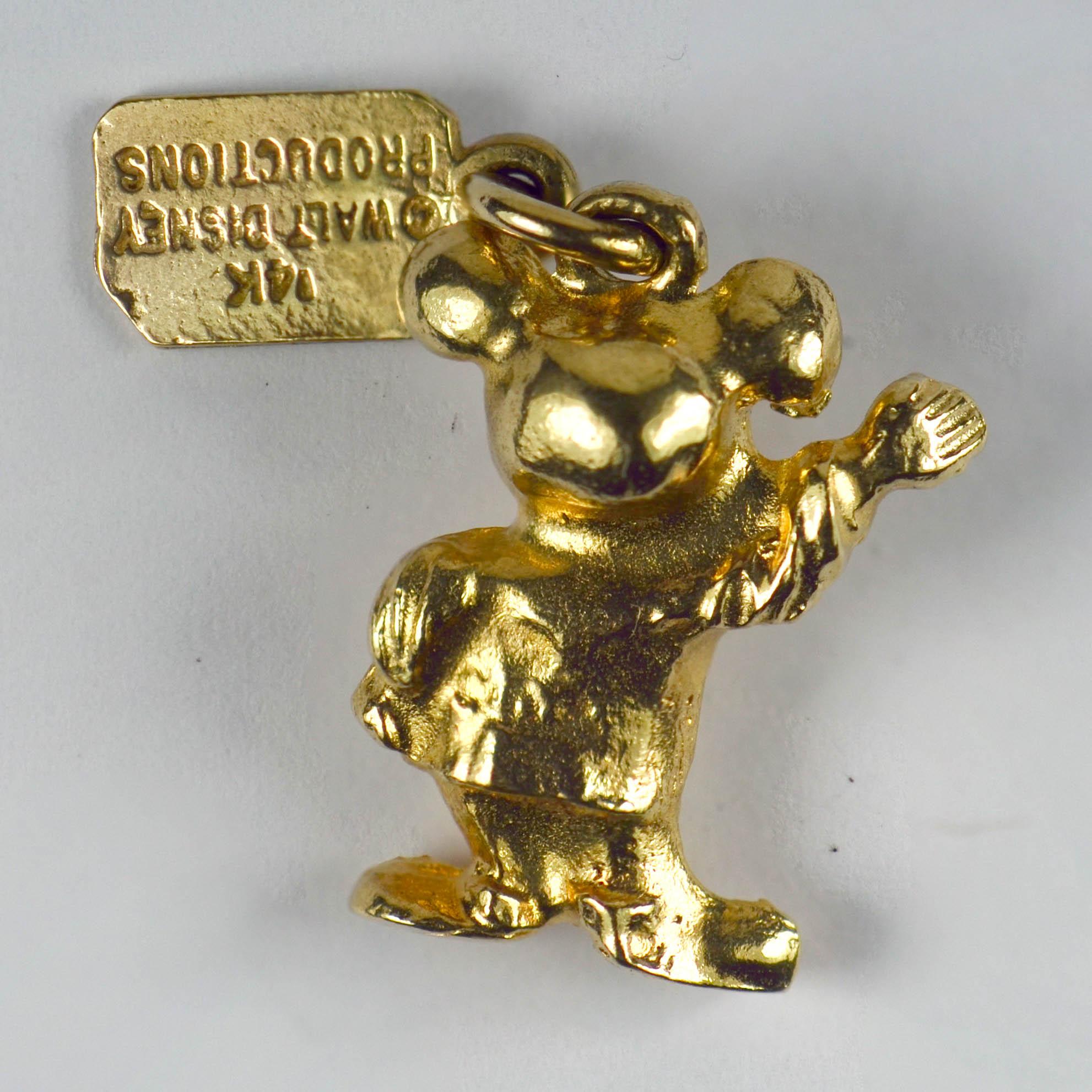 A 14 karat yellow gold charm pendant designed as Walt Disney's Mickey Mouse.
The tag attached to the charm features the DisneyWorld's logo along with the copyright for Walt Disney Productions.

Measurements: 2 x 1.5 x 0.8cm
Weight: 4.59 grams