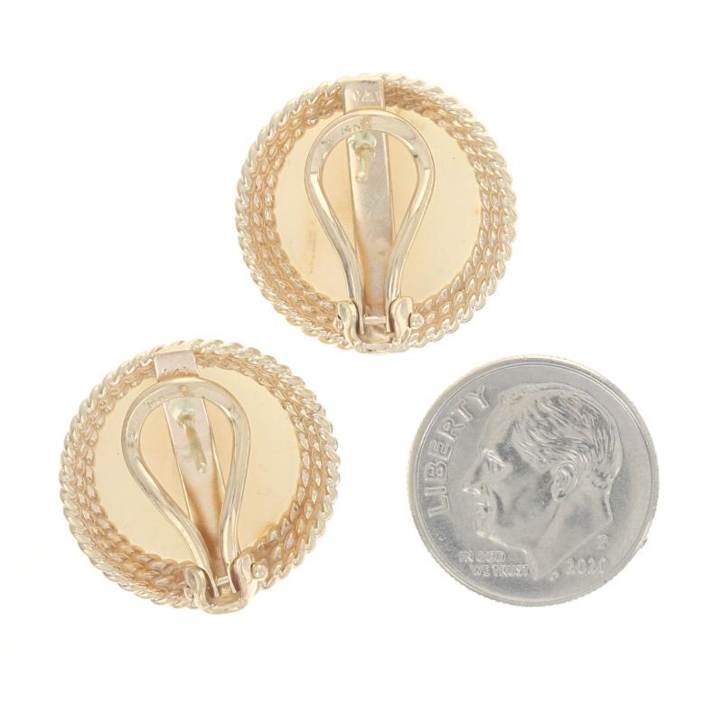 Metal Content: 14k Yellow Gold

Stone Information

Genuine White Coral 
Cut: Round Cabochon

Style: Large Stud 
Fastening Type: Omega Closures 
Features: Tiered, rope-textured borders

Measurements

Tall: 25/32