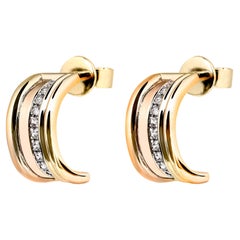 Orecchini a cerchio Queen in oro giallo e diamanti bianchi.
