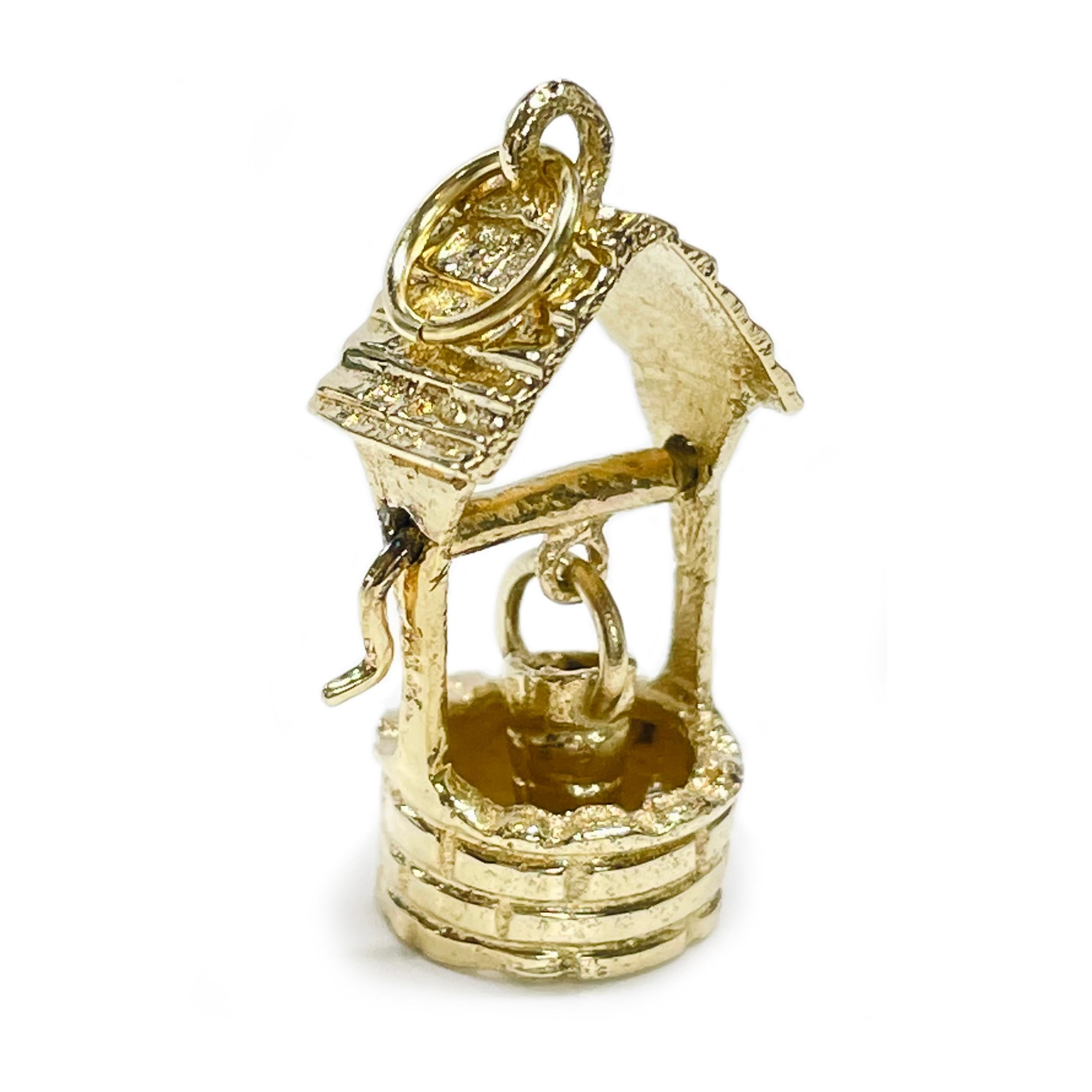 14 Karat Yellow Gold Wishing Well Pendant. This adorable pendant has a moving handle and delicately swaying bucket. The pendant measures 19 tall x 10.5mm wide. Stamped on one side of the wishing well is 14K, stamped on the other side is 14K. The