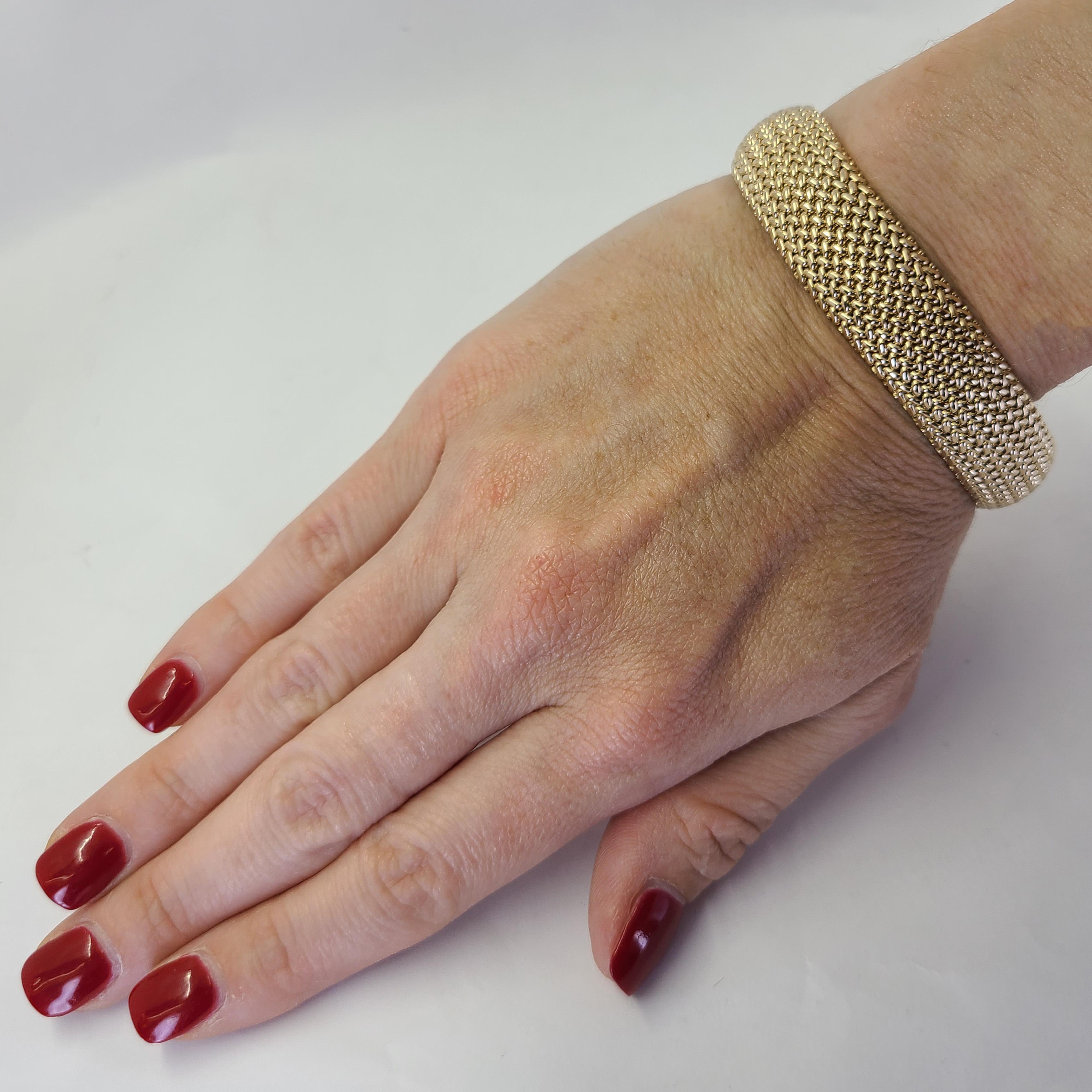 14 Karat Yellow Gold 15mm Wide Woven Mesh Bracelet with Slight Dome Shape. 7.5 Inches Long. Box Clasp with Figure 8 Safety. Finished Weight is 43.6 Grams.
