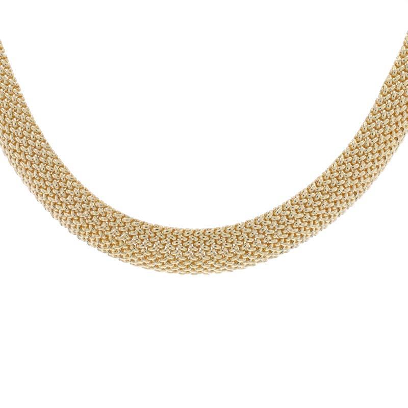 Metal Content: 14k Yellow Gold

Chain Style: Woven Mesh
Necklace Style: Chain Choker
Fastening Type: Tab Box Clasp with One Side Safety Clasp

Measurements

Length: 16 1/2