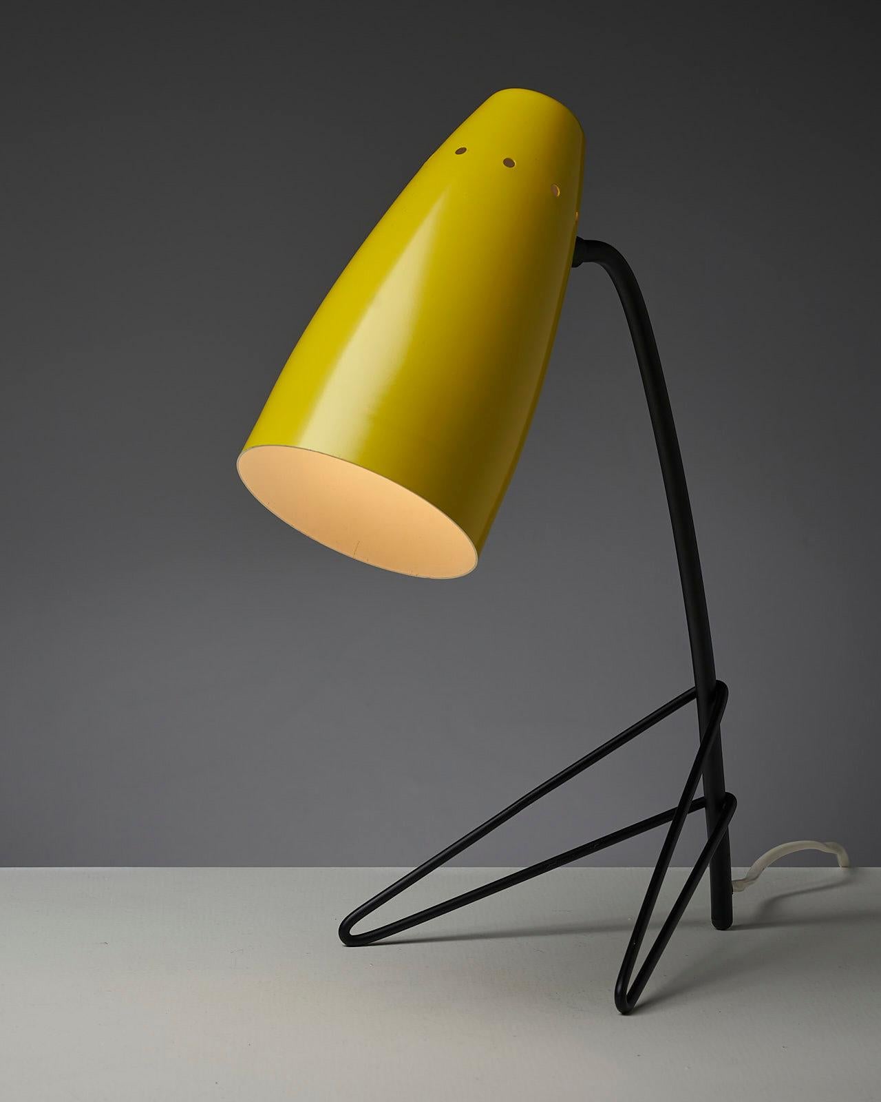 The Yellow Grasshopper is a playful and eye-catching table lamp that features a unique and distinctive design. The metal lampshade is lacquered in a vibrant yellow, which adds a pop of color to any room. The tripod base with hairpin legs is made of