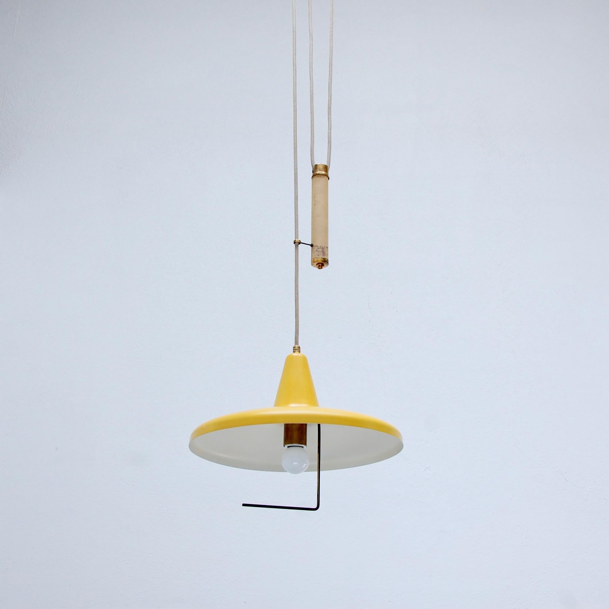 From the period, Italian 1950s pulley pendant in painted yellow aluminum, brass and leather. Original finish, partially restore. Wired with a single E26 medium based socket for the US. Light bulb included. Overall drop