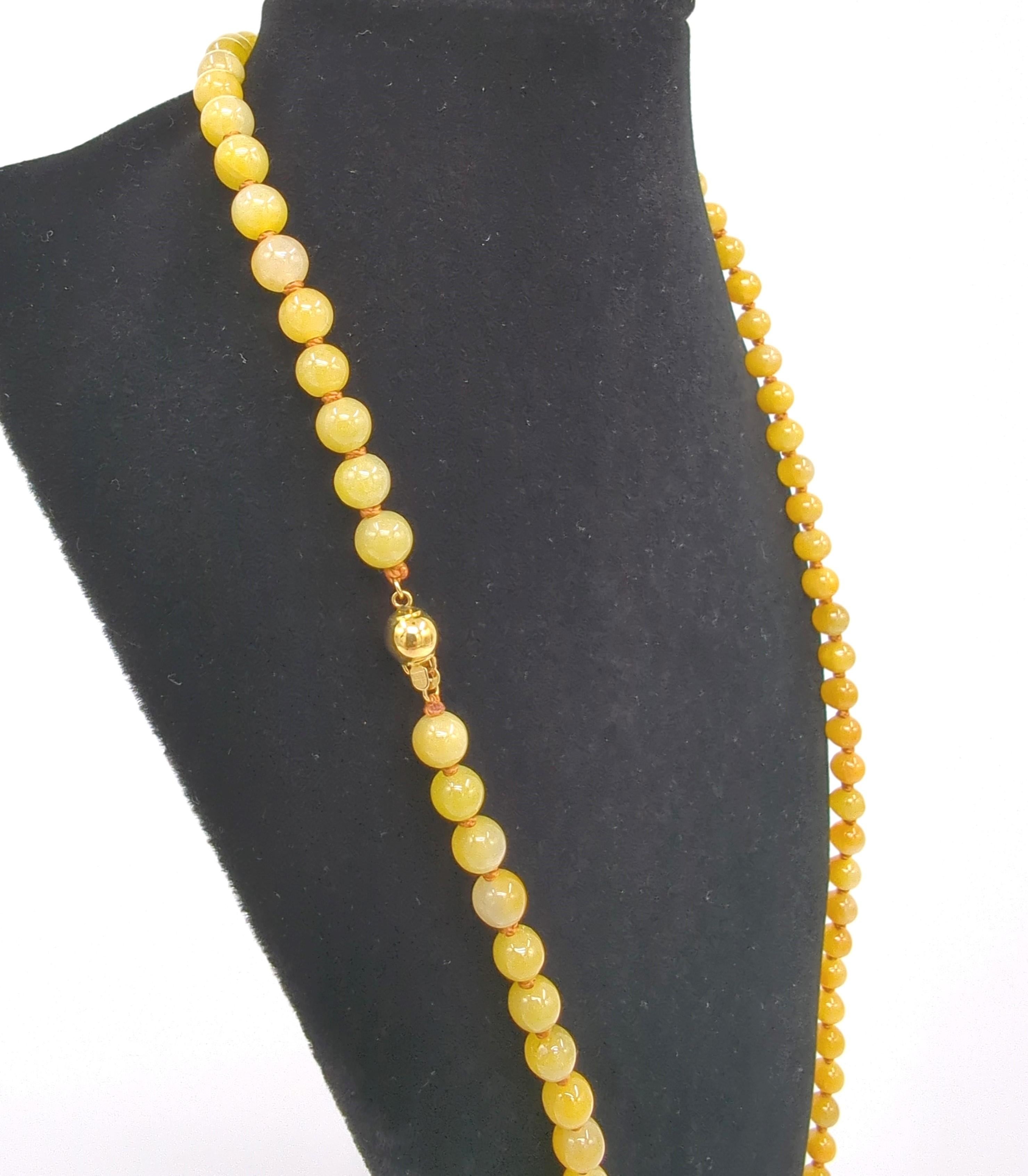 This stunning necklace features a strand of A-grade jadeite beads, each meticulously selected for its intense yellow hue. The bold coloration of the jadeite makes a striking statement, capturing attention and elevating any ensemble. The necklace is