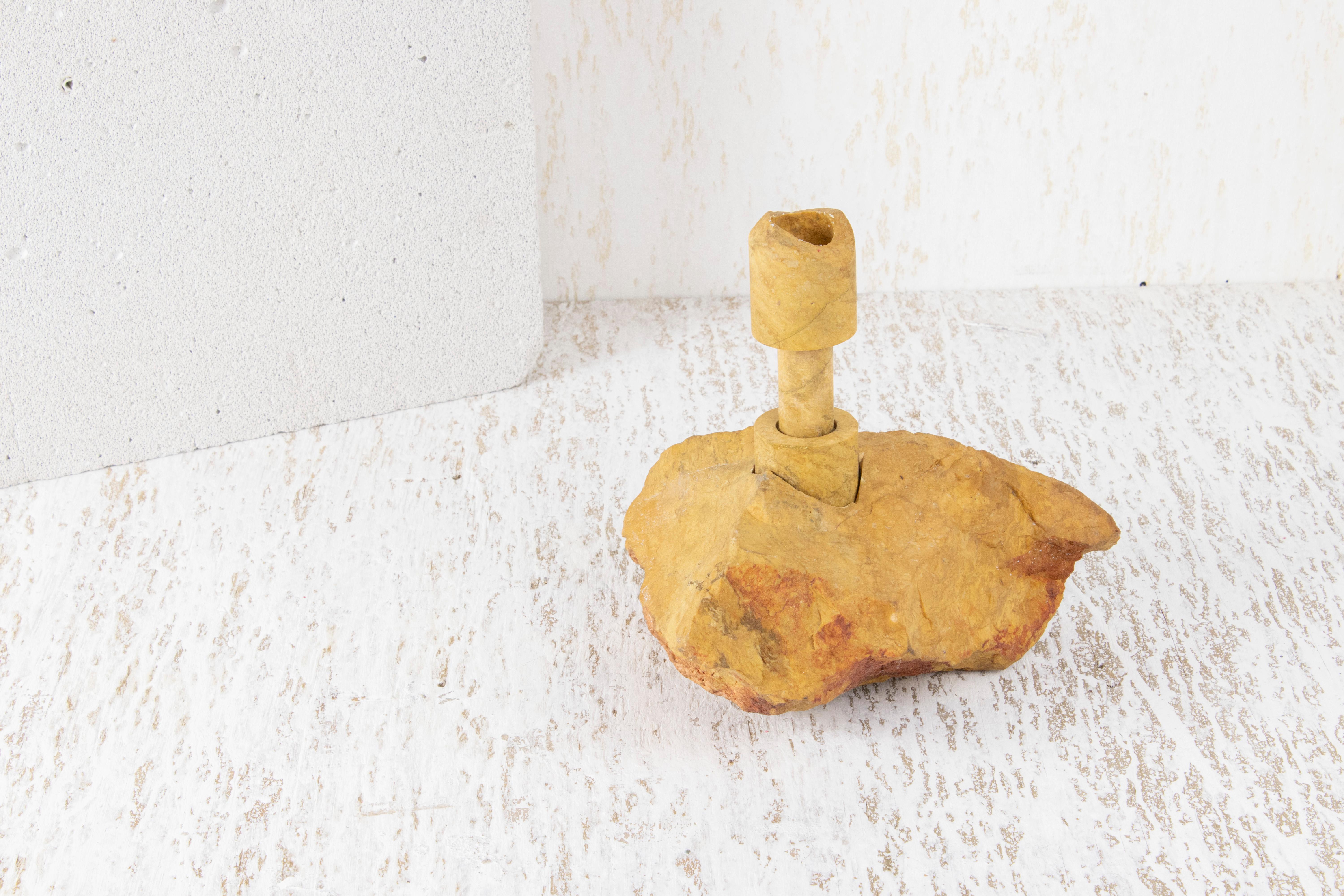 Yellow Jasper Abra Candelabra by Studio DO
Dimensions: D 18 x W 15 x H 18.5 cm
Materials: Yellow jasper, brass.
2.5 kg.

Stone and fire are connected in an ageless bond. A sparkle created by clashing two stones with each other has been igniting fire
