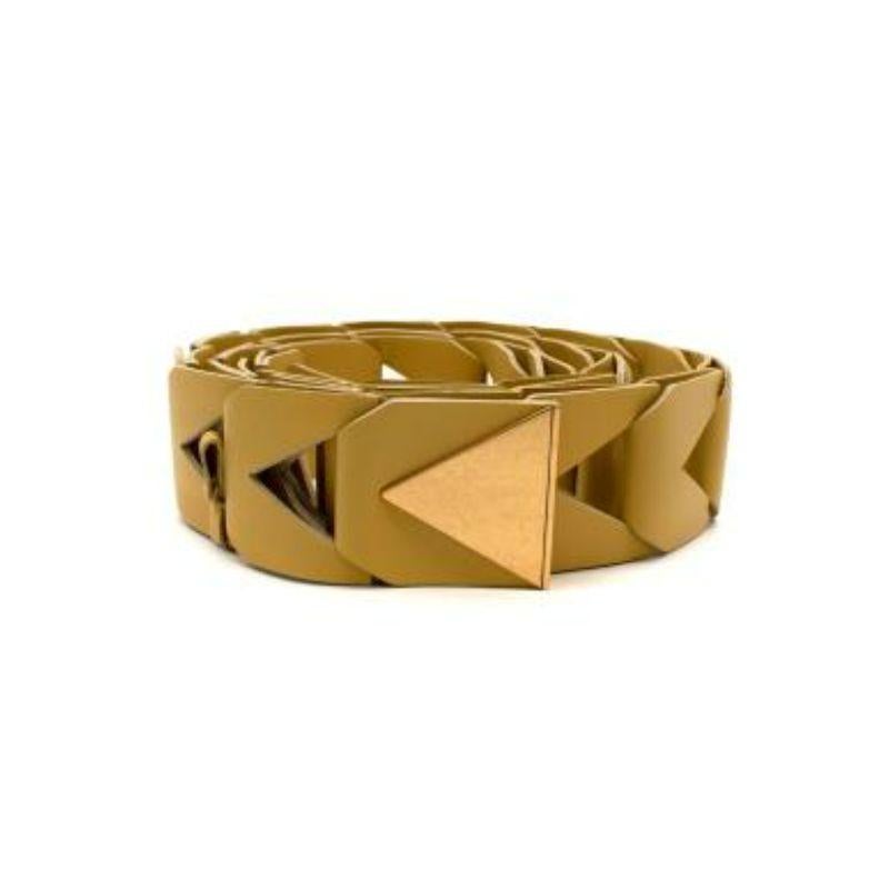 Bottega Veneta Yellow Leather Chain Link Belt
 
 - Braided leather belt with triangular shaped cut out sections in muted yellow hue 
 - Gold tone triangle buckle with subtle embossed branding 
 
 Materials 
 Leather 
 Metal 
 
 Made in Italy 
 
