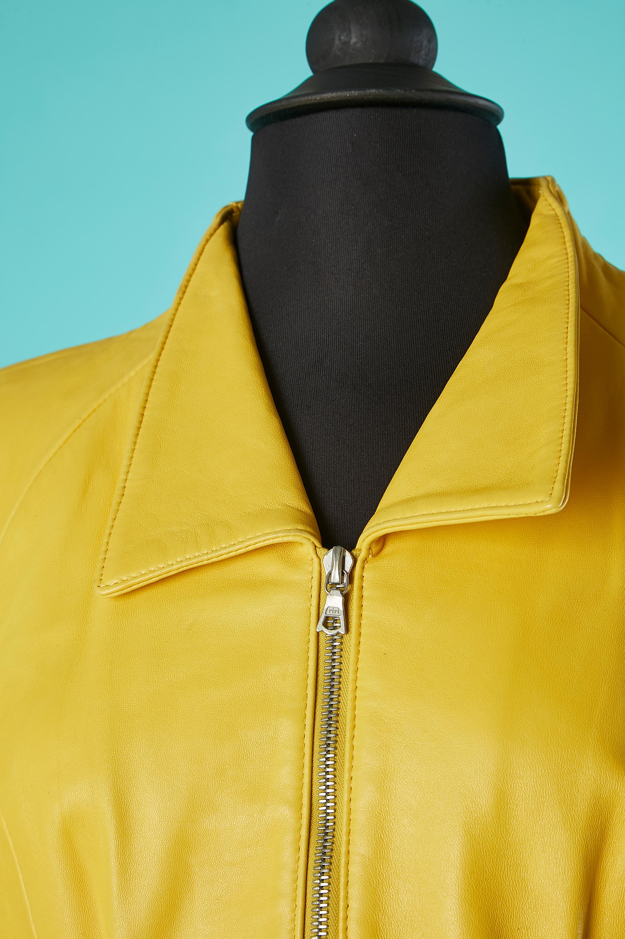 Yellow leather skirt-suit. Rayon lining. 
Raglan sleeves. Zip middle front, on pockets and cuffs. Shoulder-pads. Cut-work.
SIZE 7/8 ( on tag) but fit M ( jacket ) and XS ( skirt) 