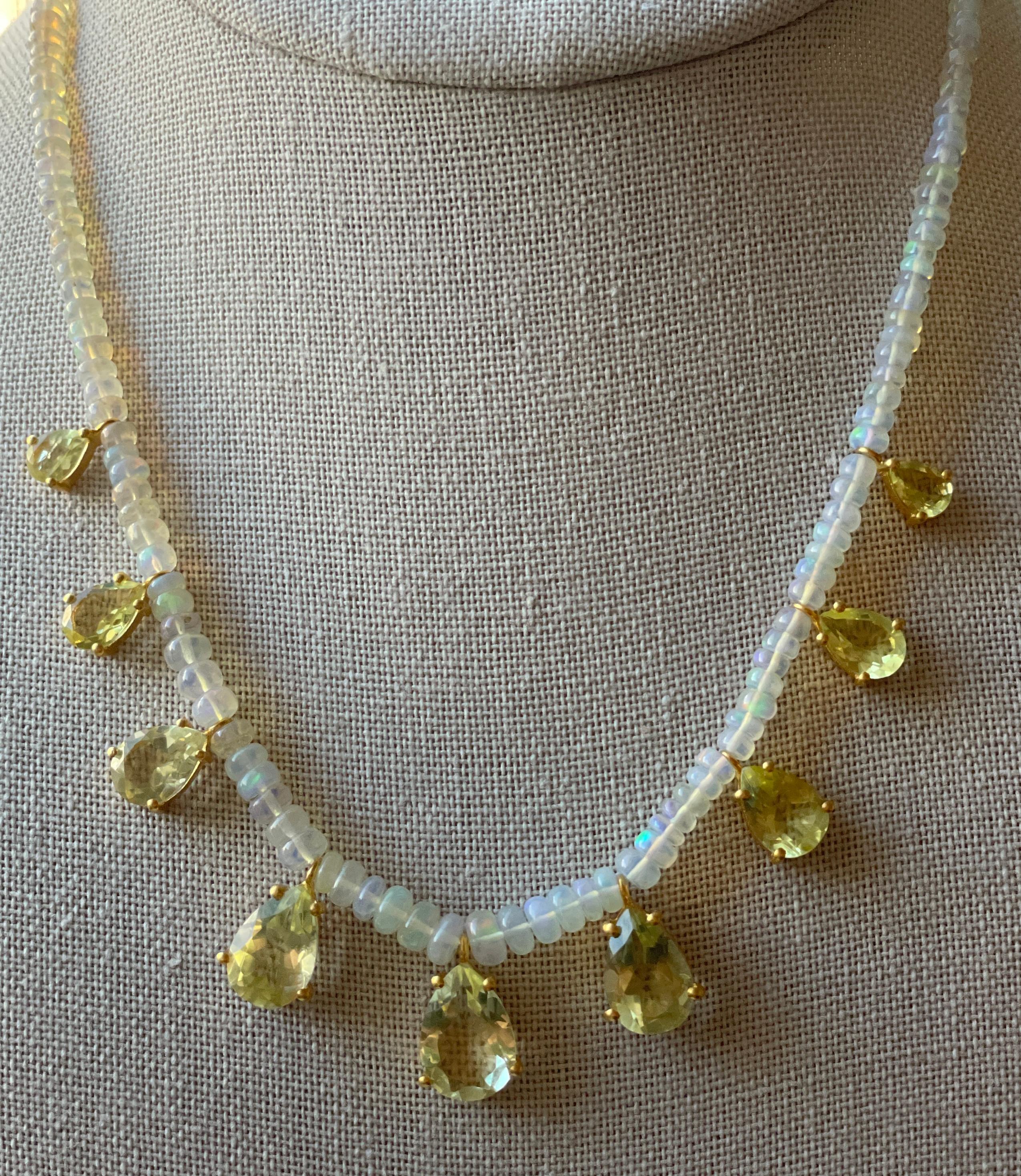 This gorgeous Opal and Lemon Topaz beaded necklace is comprised of 9 pear cut Lemon Topaz stones that are weighing over 20 carats. They are set in 14K matte gold plating which displays soft hues and tones of gold. The setting is minimal allowing for