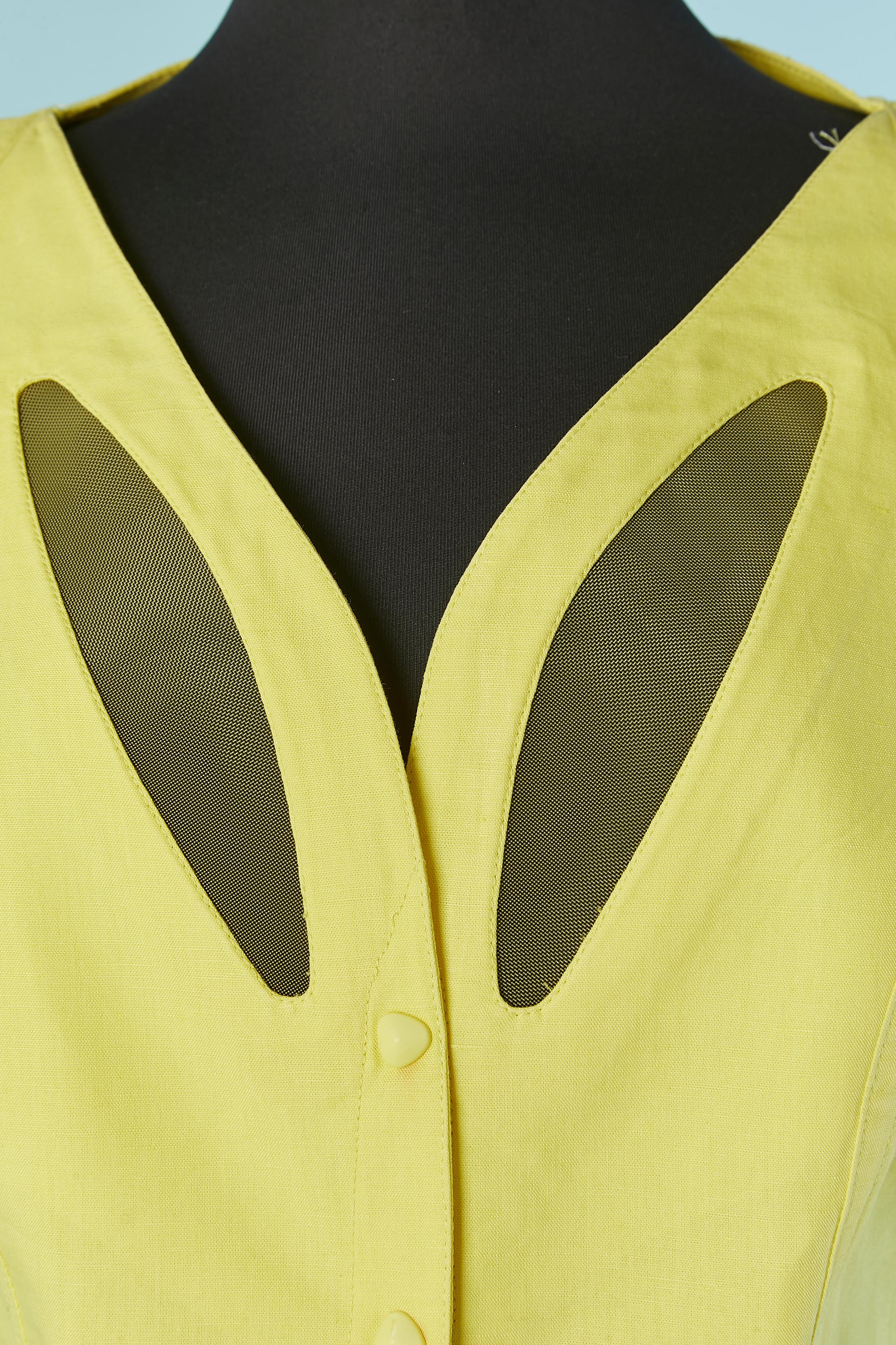 Yellow linen and cotton dress with tulle inset. Fabric composition: 5% nylon ( stiff see-through tulle) 55% linen, 60% cotton. 
Snap closure on the middle front. Cut-work. Top-stitching. Shoulder-pad.
SIZE L