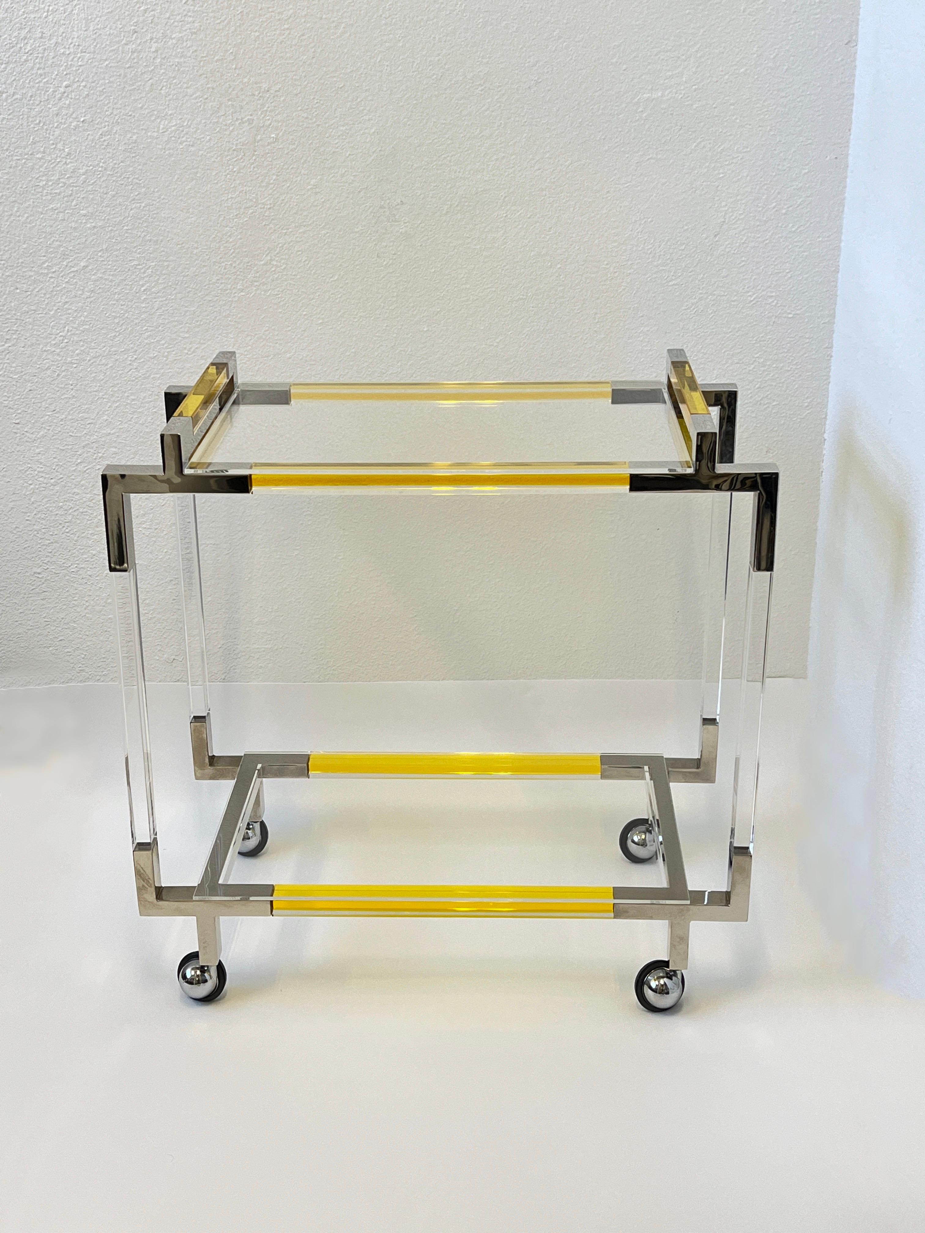 Polish chrome and lucite two tier bar cart by American renowned designer Charles Hollis Jones. 
Part of his new limited edition work, Seeing in color. 
Measurements: 17” Deep, 32” Wide, 31.75” High.