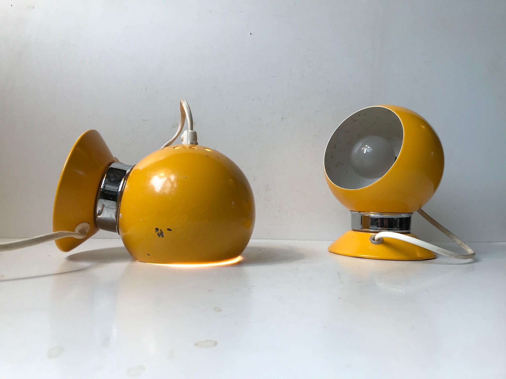 Vintage wall or bedside globe shaped lights manufactured by ABO in Denmark during the early 1970s. These ball lamps with magnetic bases are easily adjustable and removable.