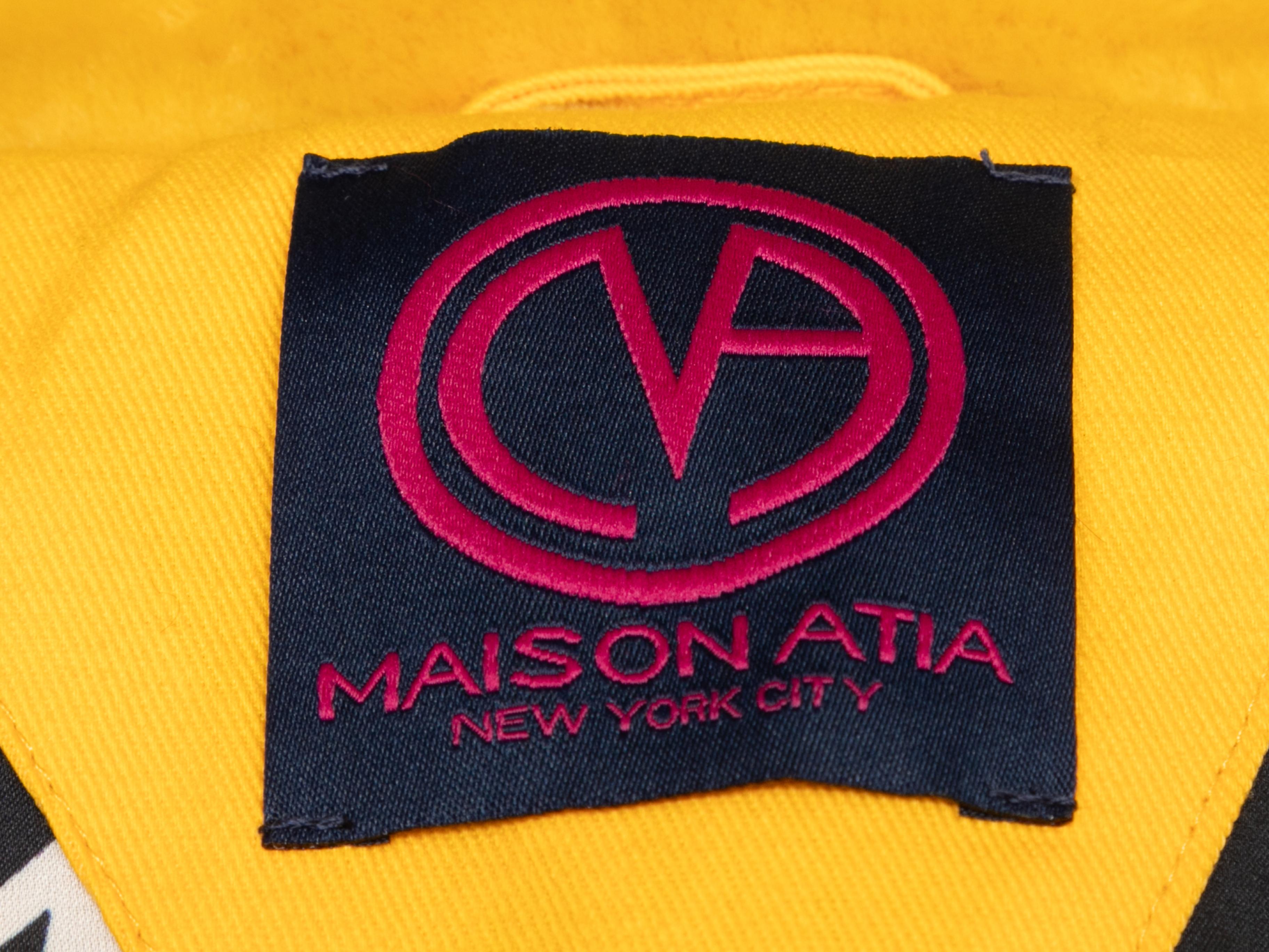 Yellow faux fur Genevieve coat by Maison Atia. Notched lapel. Dual hip pockets. Sash tie closure at waist. 30