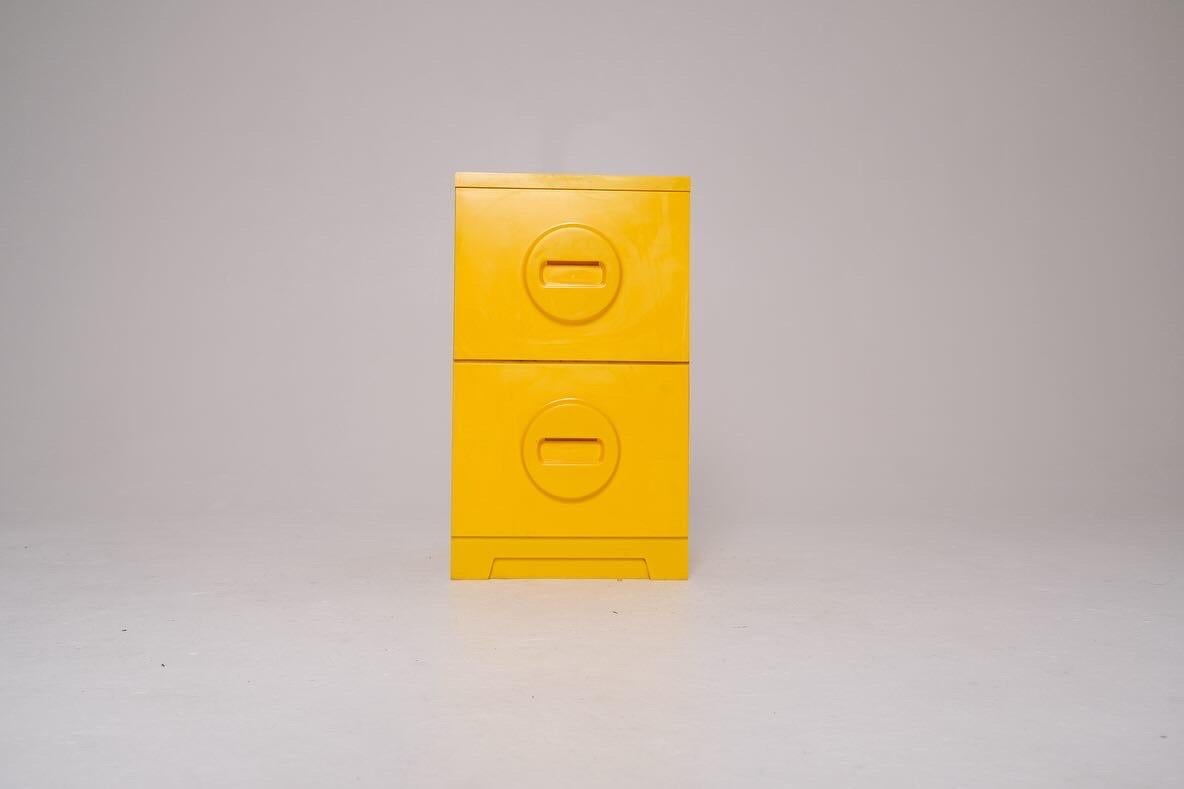 Brighten up your workspace with this bold and functional vintage two-drawer file cabinet by Akro-Mils, manufactured in Akron, Ohio. Made of durable molded plastic in a vivid sunflower yellow, this piece epitomizes playful utilitarian design from the