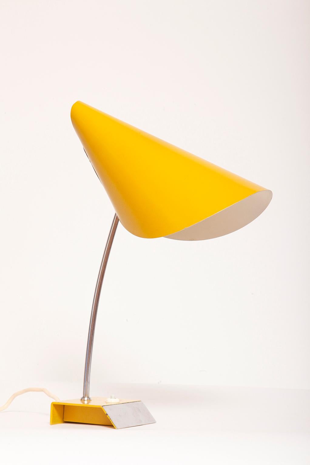 Czechoslovakian desk lamp, with a great ergonomic shape.

A lamp commonly called a nun. I've never seen anyone wearing yellow clothes, but what do I know about spiritual life in Czechoslovakia?
Well, not much, not to say nothing.

Preserved in good