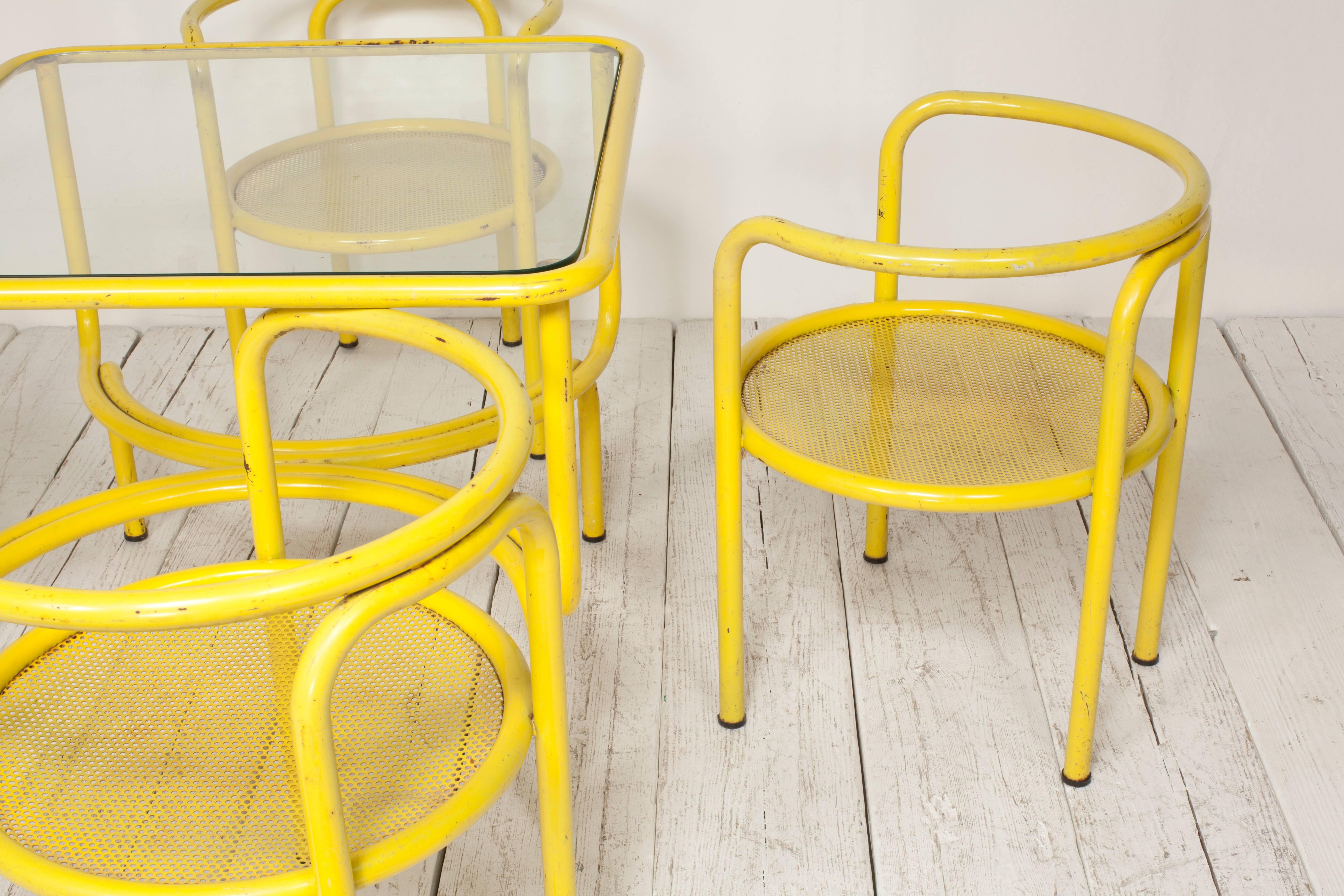 Yellow metal tubular dining table set with four matching circular chairs by Gar Aulenti 

Table measures: 30.5