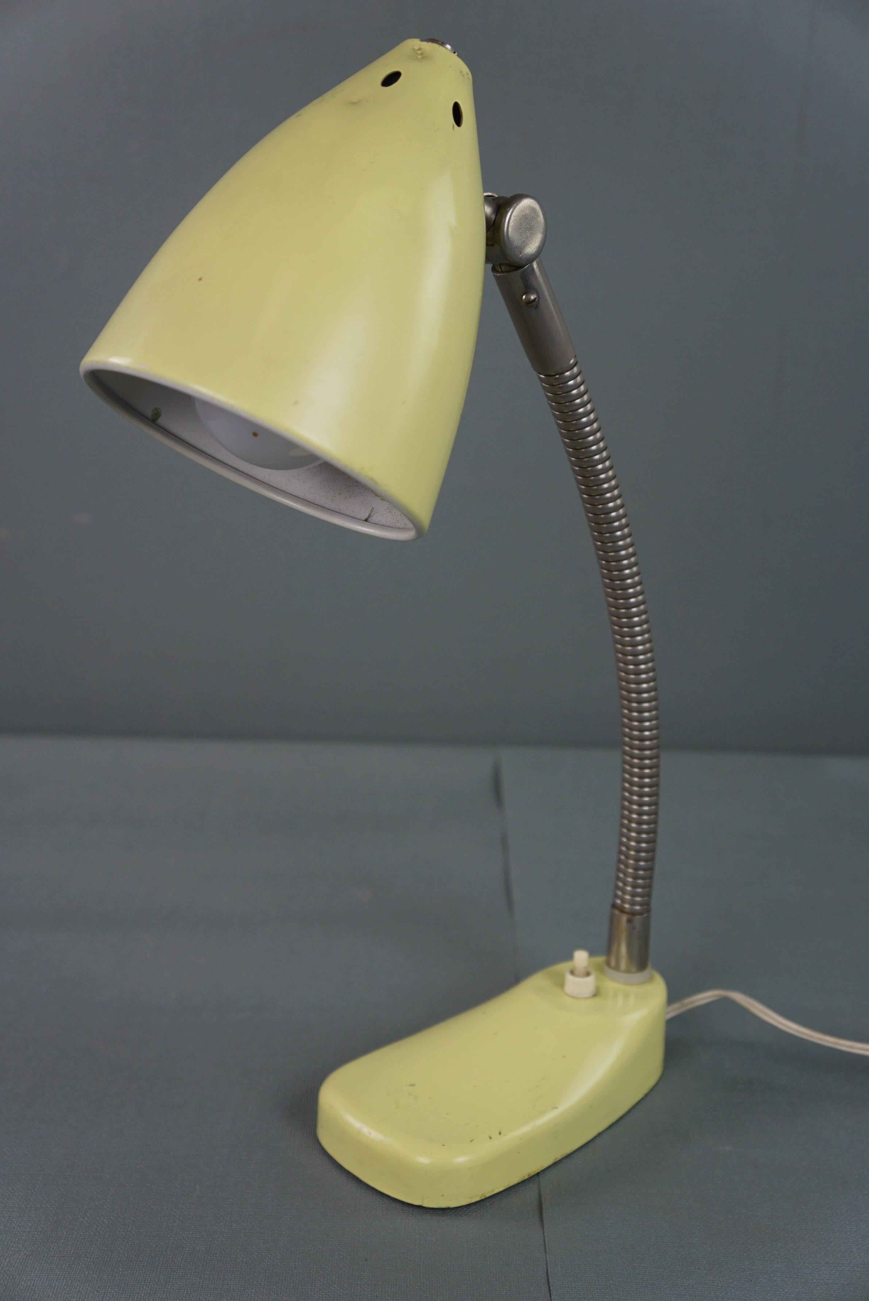 Offered is this lovely yellow metal vintage 1960s design lamp/desk lamp. This vintage desk lamp is perfect for use in the home, office, or bedroom. The neck is bendable, allowing you to always have the right angle of illumination. The lamp can be