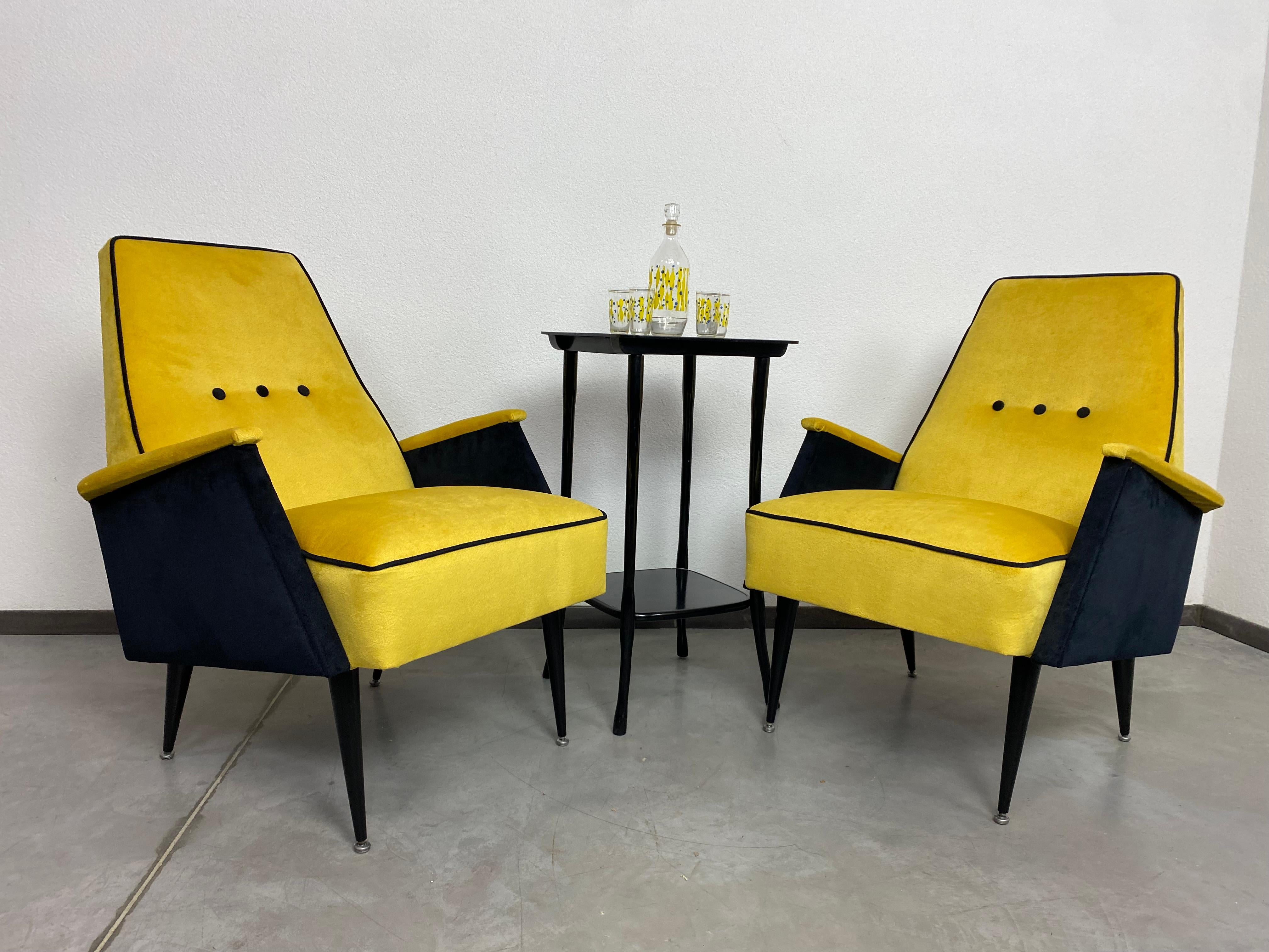 Yellow mid-century design armchairs after professional renovation.