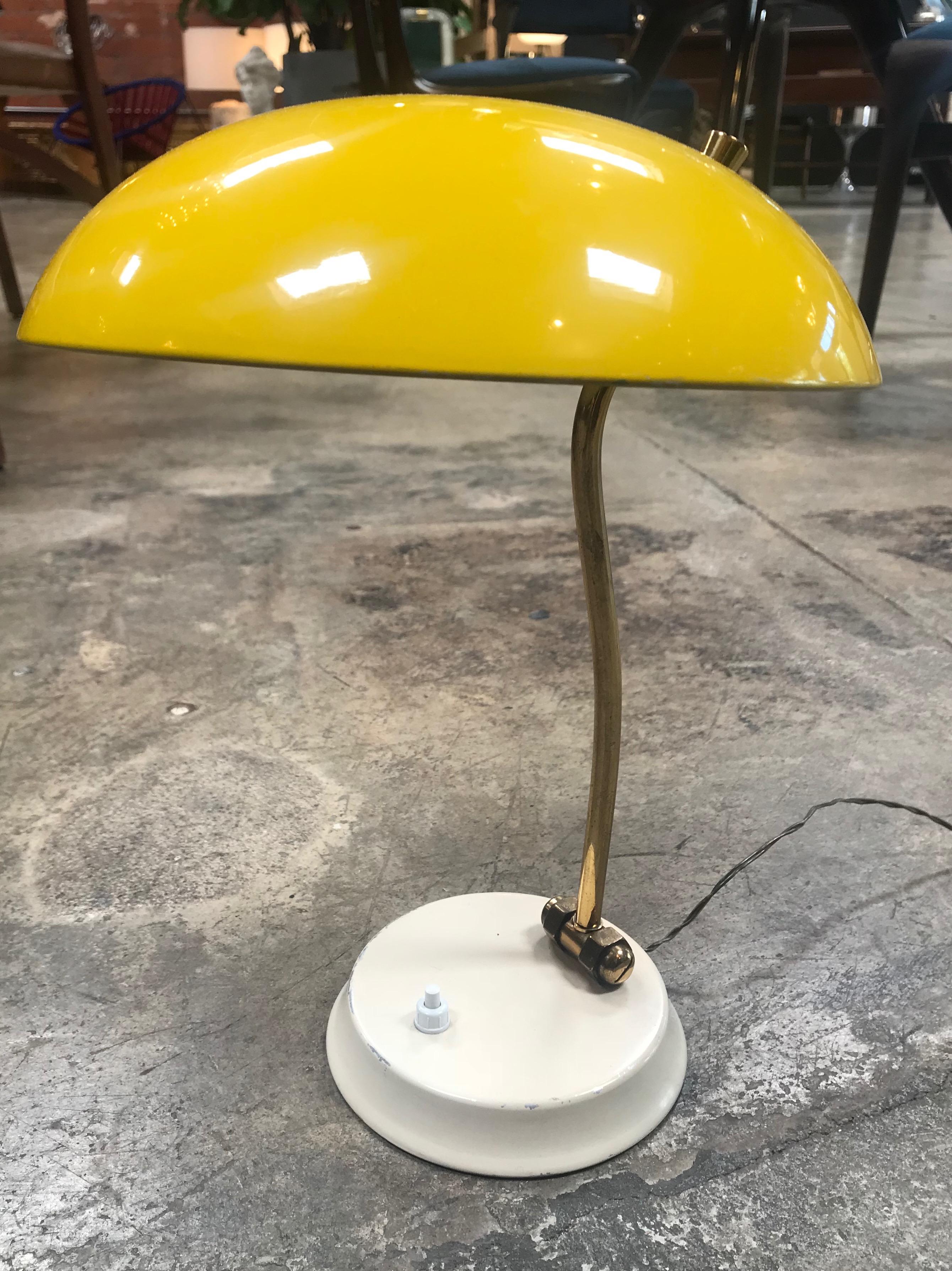 Italian vintage yellow table lamp from 1950s, the arm in brass and shade are adjustable.
Chrome-plated body with metal painted in white.
Very nice patina. Fully functional.
 