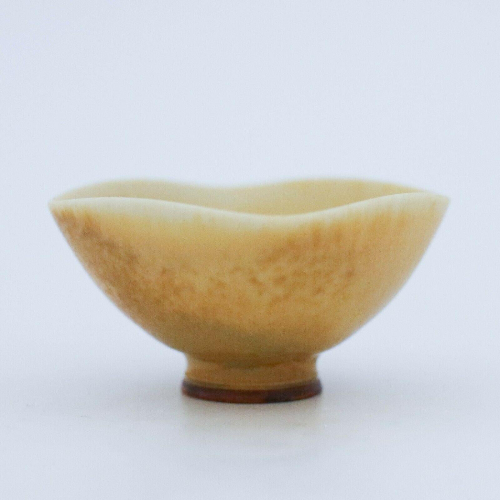 A lovely yellow miniature bowl designed by Berndt Friberg at Gustavsberg in Stockholm, the bowl is 4.2 cm in diameter with a lovely harfur glaze. It ´s marked as on picture.