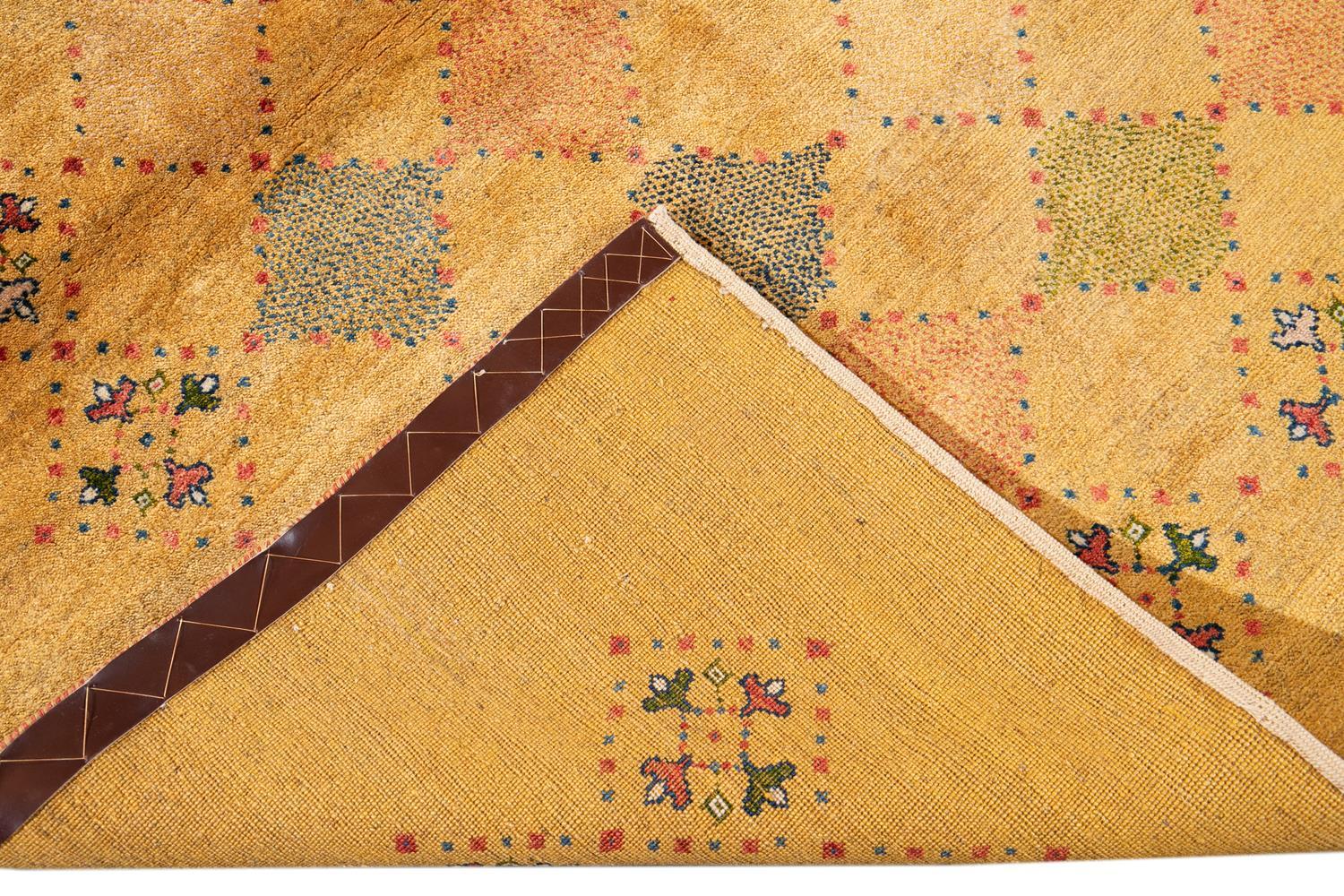 Beautiful contemporary Persian Gabbeh hand knotted wool rug with a goldenrod field. This Gabbeh rug has multi-color accents in a gorgeous geometric diamond pattern design.

This rug measures 5' 2